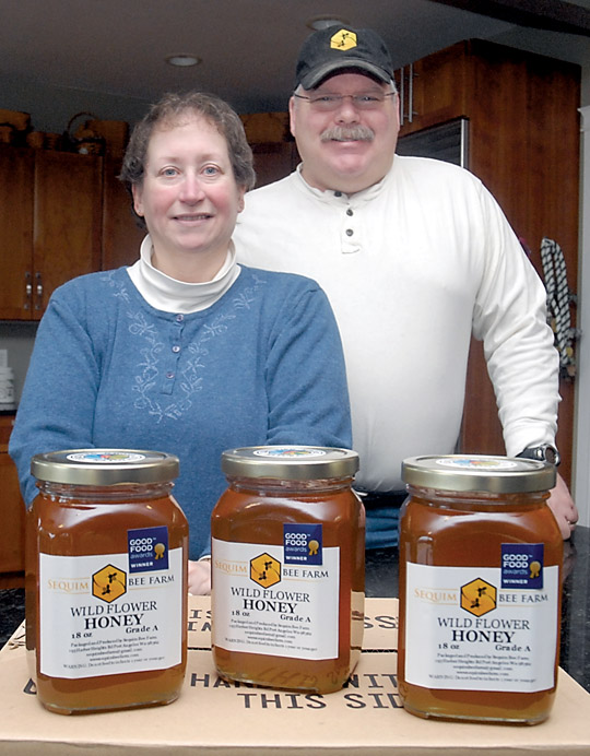 Meg and Buddy Depew of Sequim Bee Farm show off jars of their Wild Flower Honey