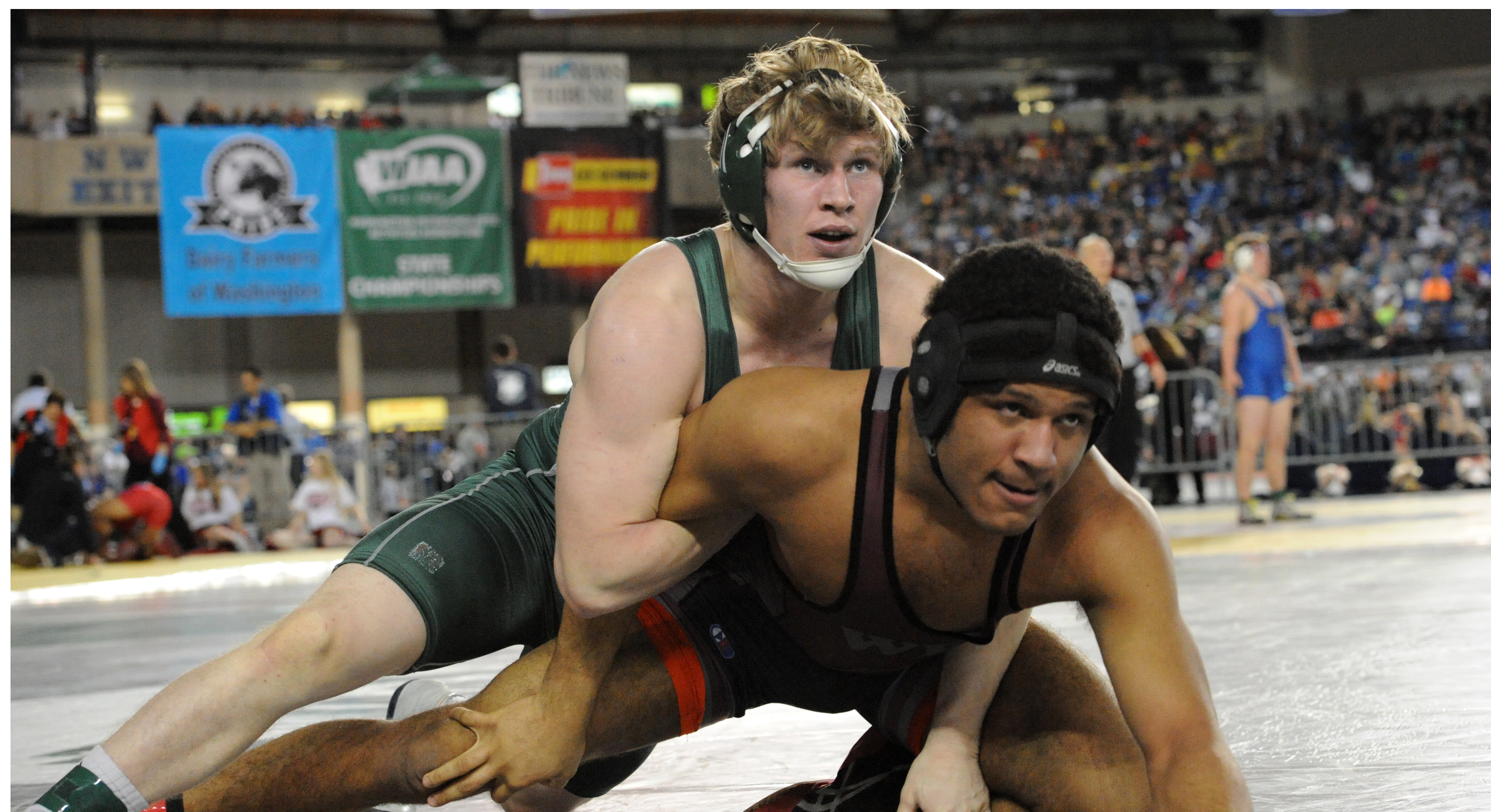 Port Angeles' Matt Robbins wrestles W.F. West's Allan McClure during the Class 2A 195-pound semifinals. Robbins