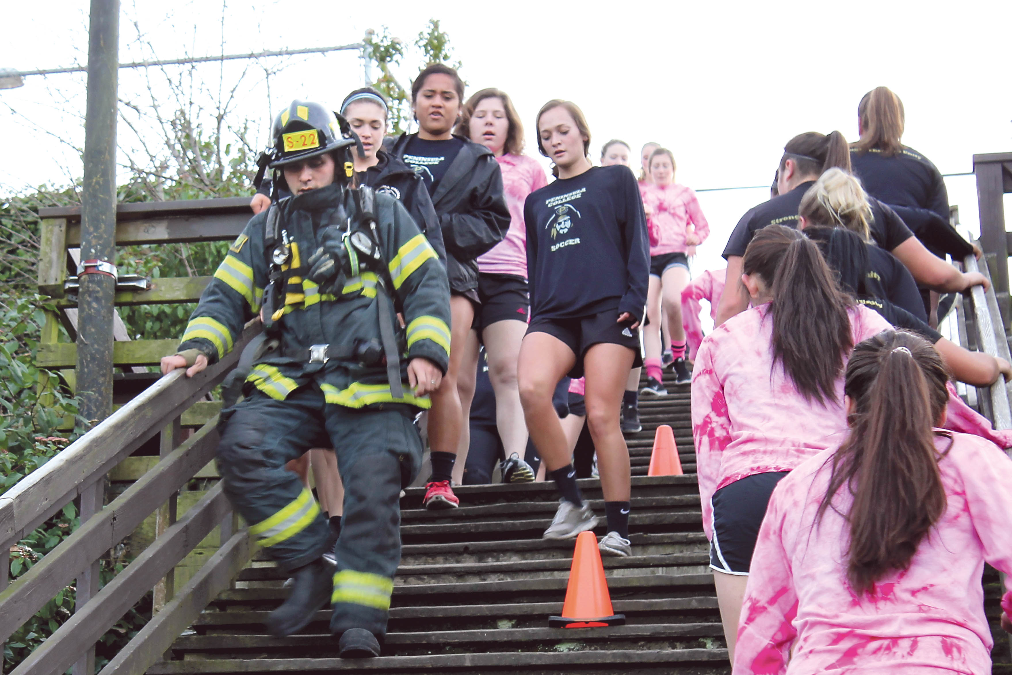 Area students work out with Port Angeles firefighters Feb. 16 at the staircase behind the Conrad Dyar Memorial Fountain at First and Laurel streets in Port Angeles. (Rob Edwards)