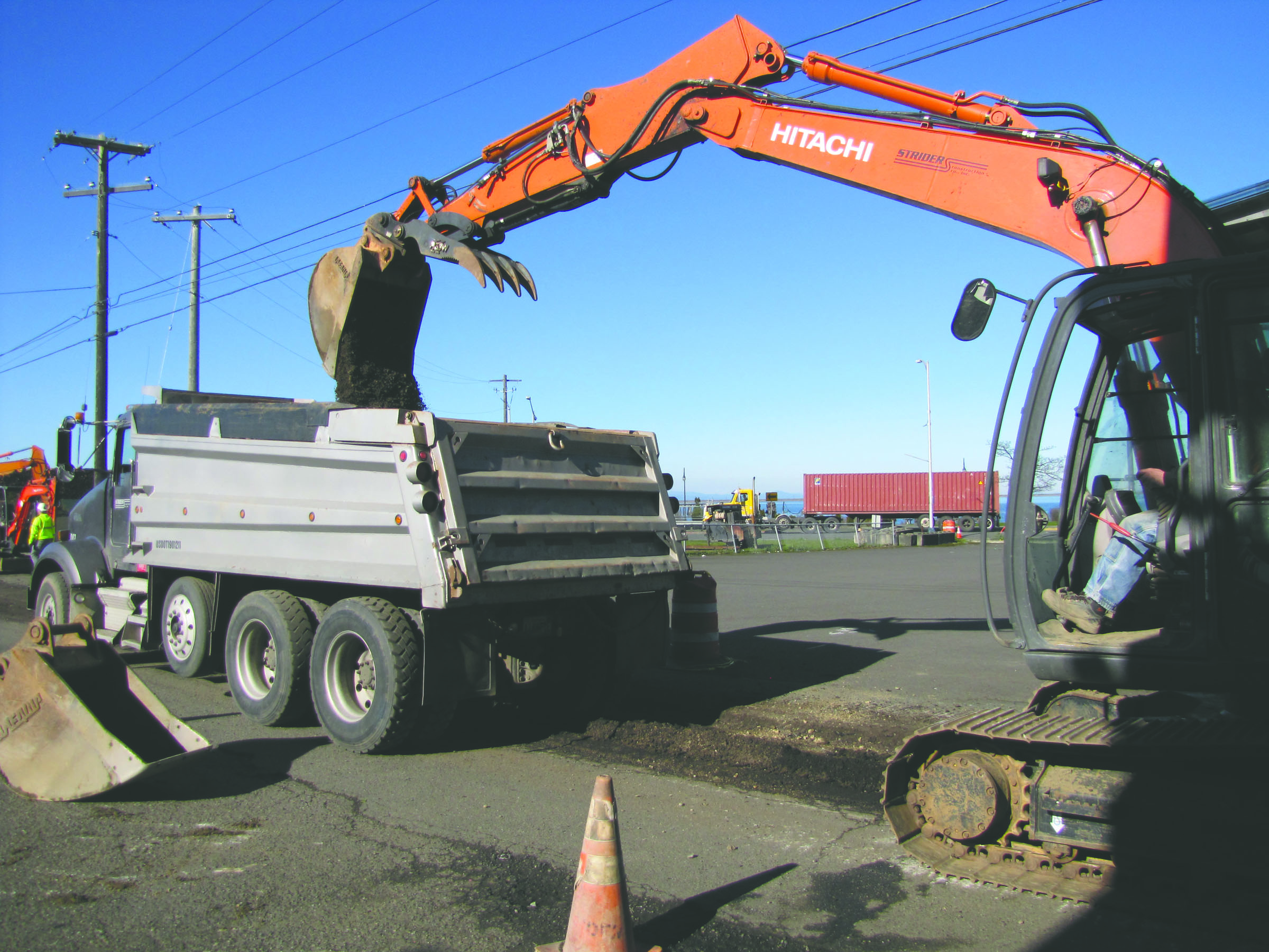 Construction workers from TEK Construction Inc. of Bellingham excavate a trench in the alley between Front and First streets