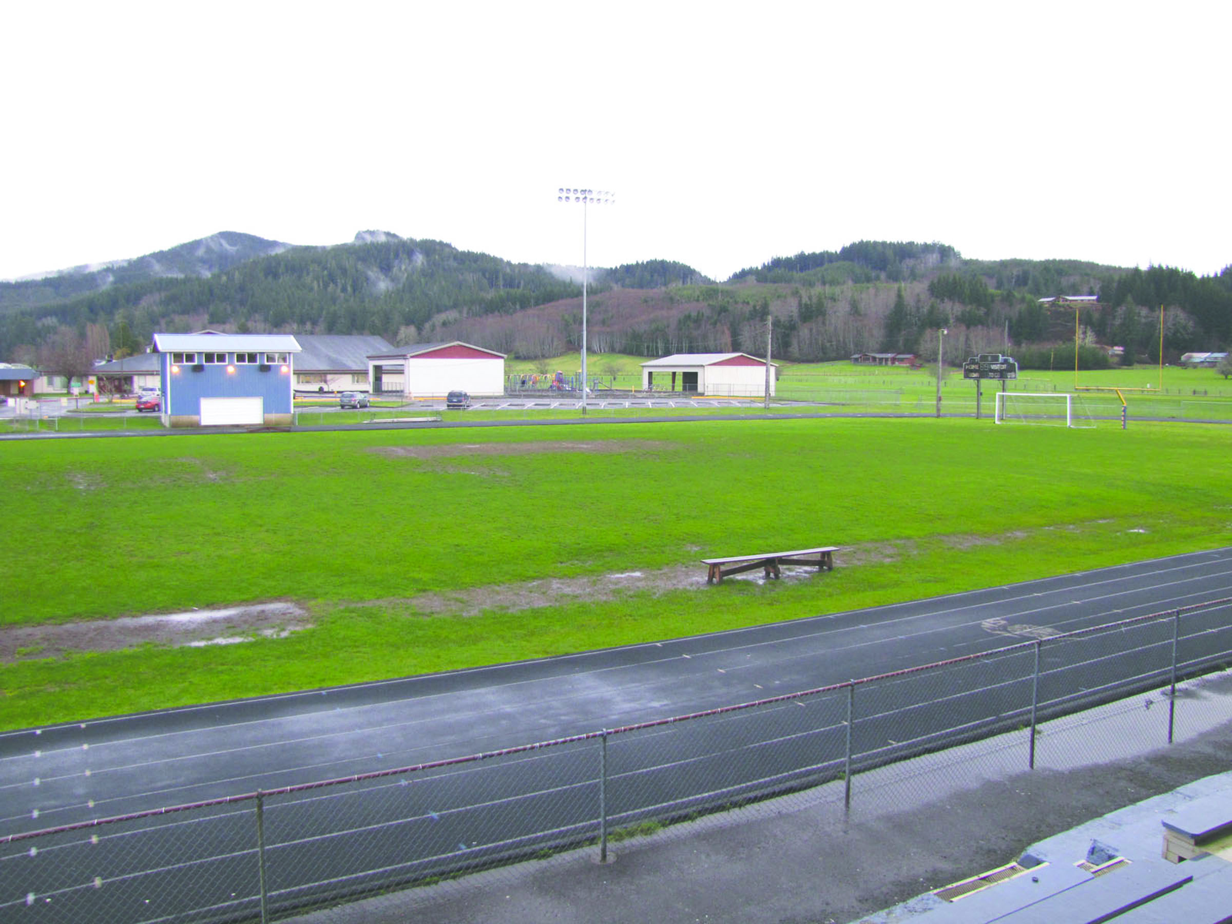 The muddy football field at Forks High School is expected to undergo a major transformation into a $1.25 million artificial turf field with a freshly resurfaced track this summer. — Arwyn Rice/Peninsula Daily News ()