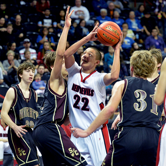 Neah Bay guard Kenrick Doherty (22) attacks the basket against Sunnyside Christian's CLane Marsh