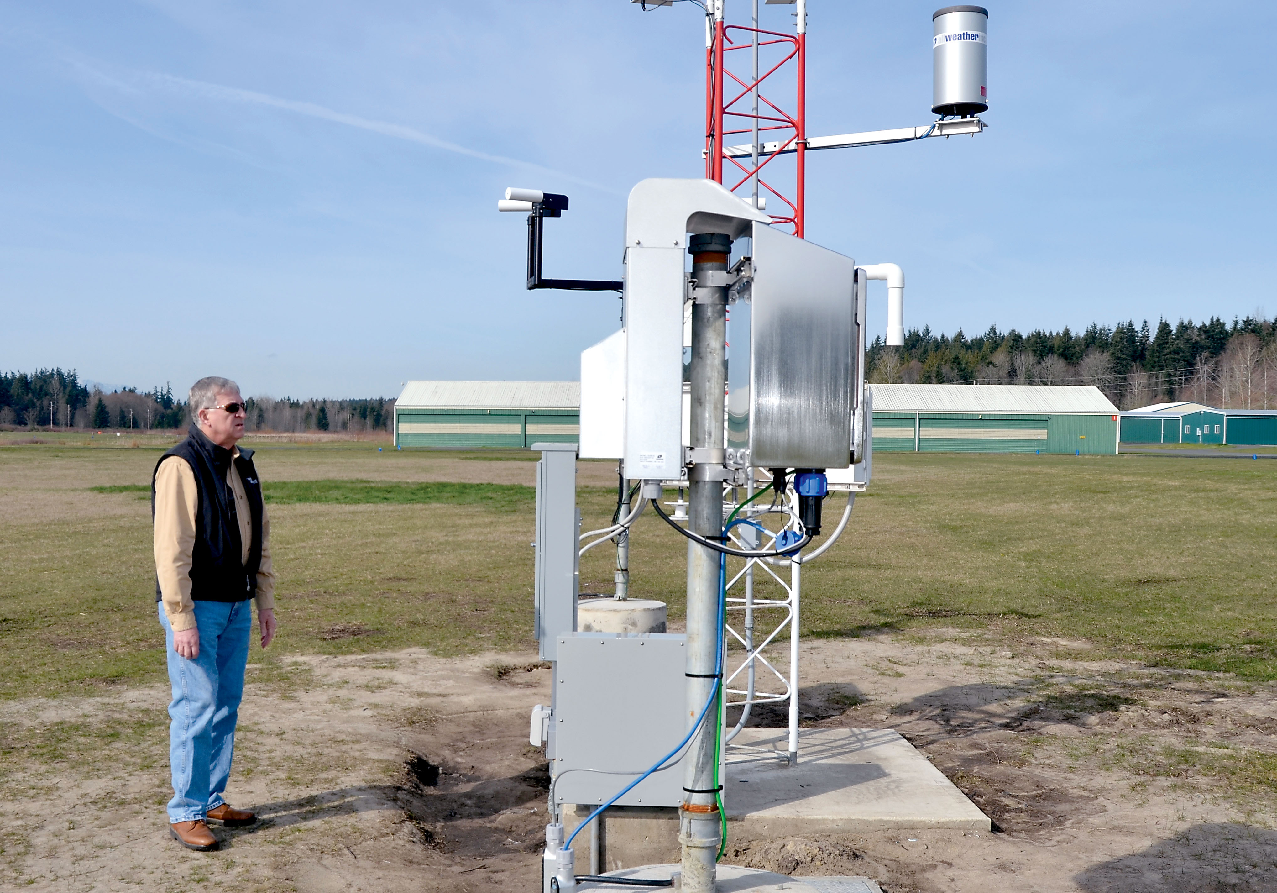 Port of Port Townsend Director Larry Crockett inspects the newly installed AWOS weather reporting system at Jefferson County International Airport. — Charlie Bermant/Peninsula Daily News ()