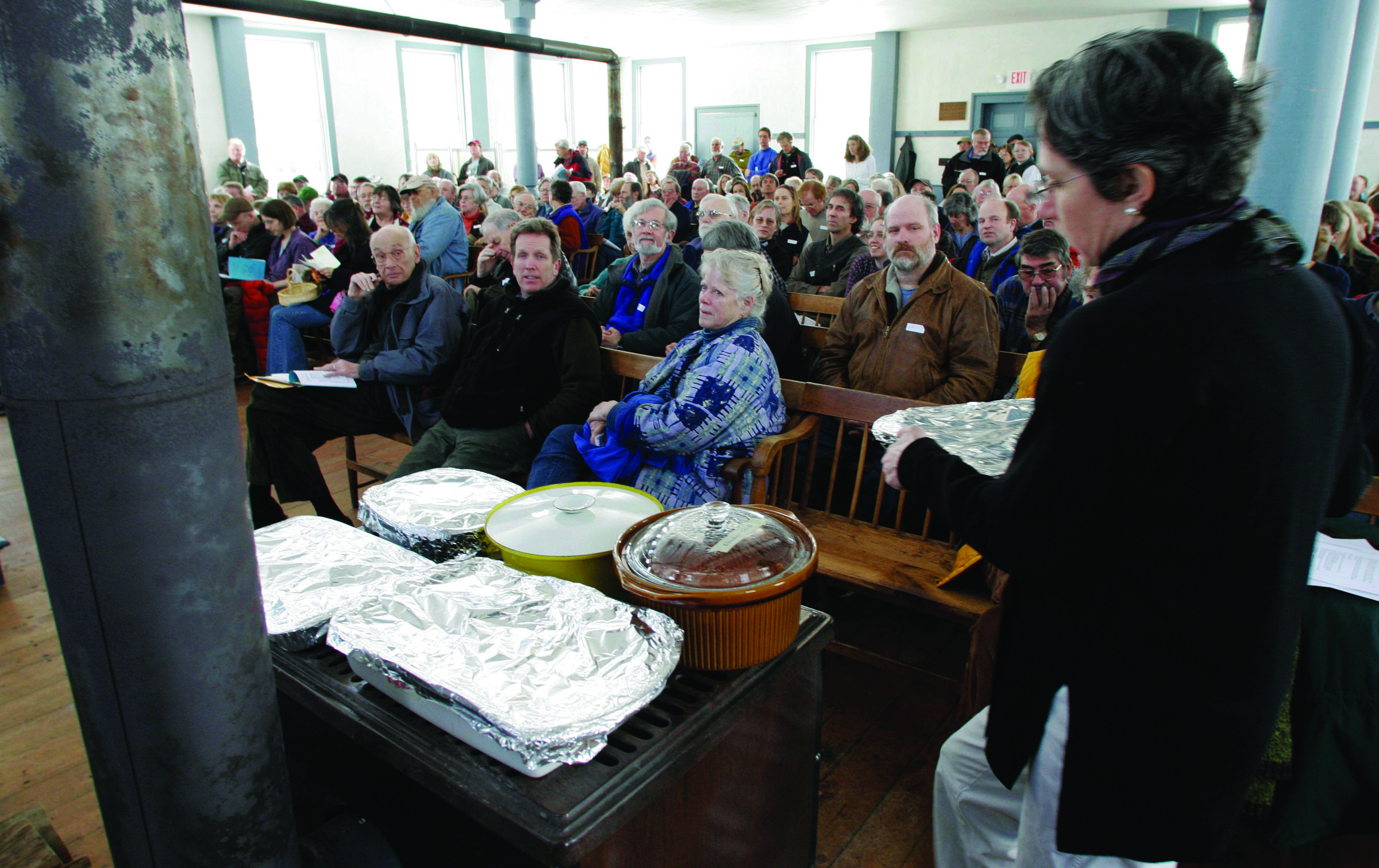 Food warms on a wood stove during a town meeting in Strafford