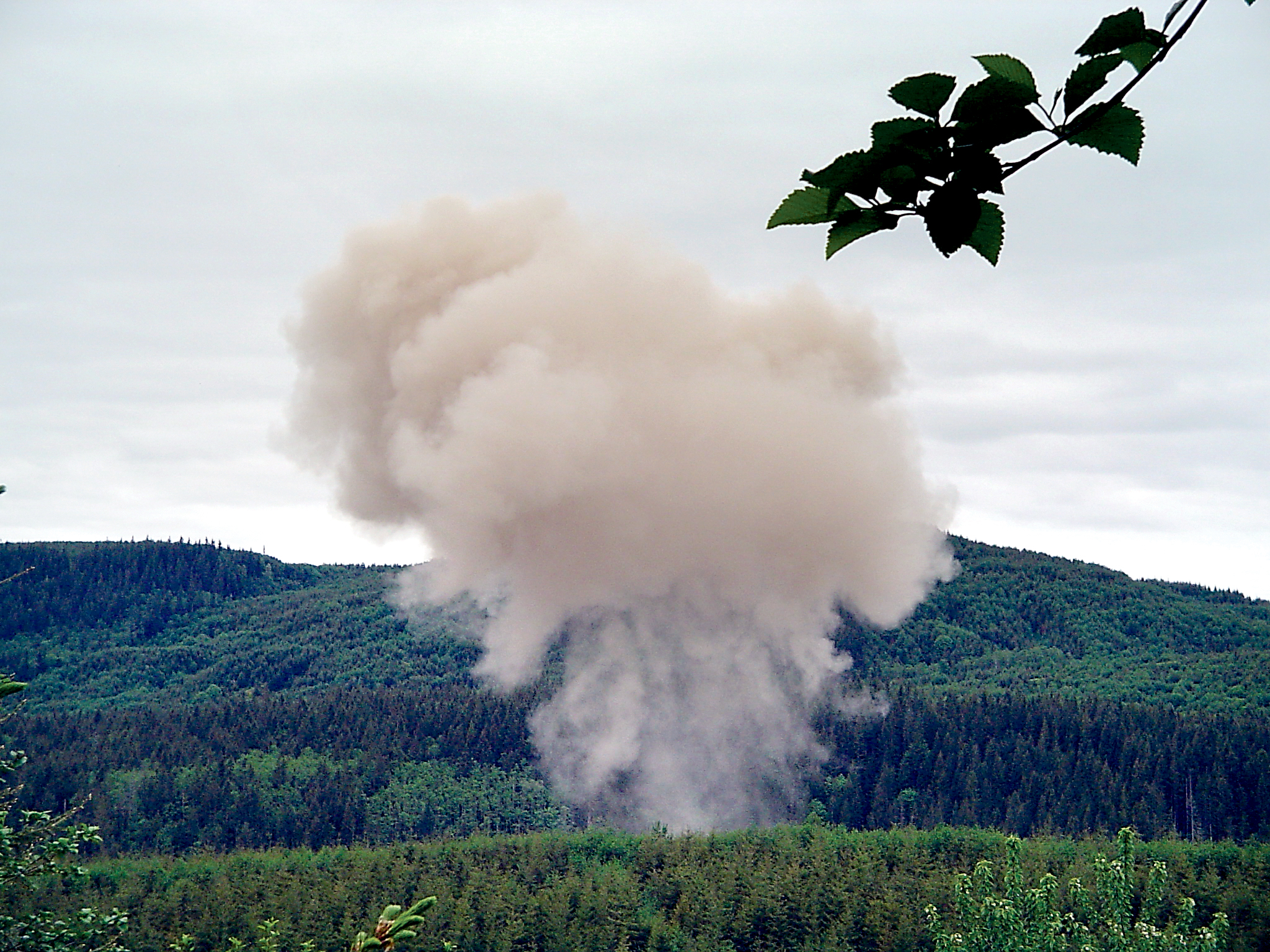 A cloud of smoke rises above the Souriau PA&E Bonded Metals blasting site west of Joyce. — Souriau PA&E Bonded Metals ()
