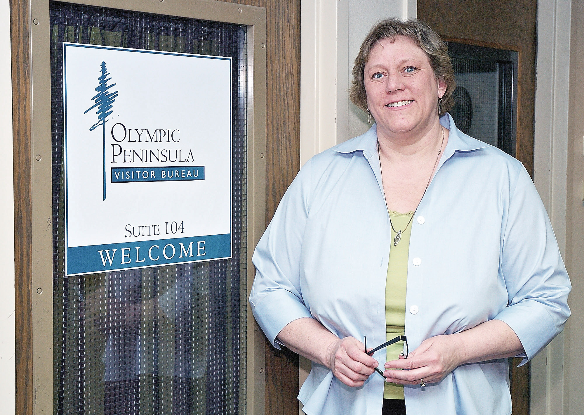 Diane Schostak stands outside the door to the Olympic Peninsula Visitor Bureau in Port Angeles. (Peninsula Daily News 2009 file photo)