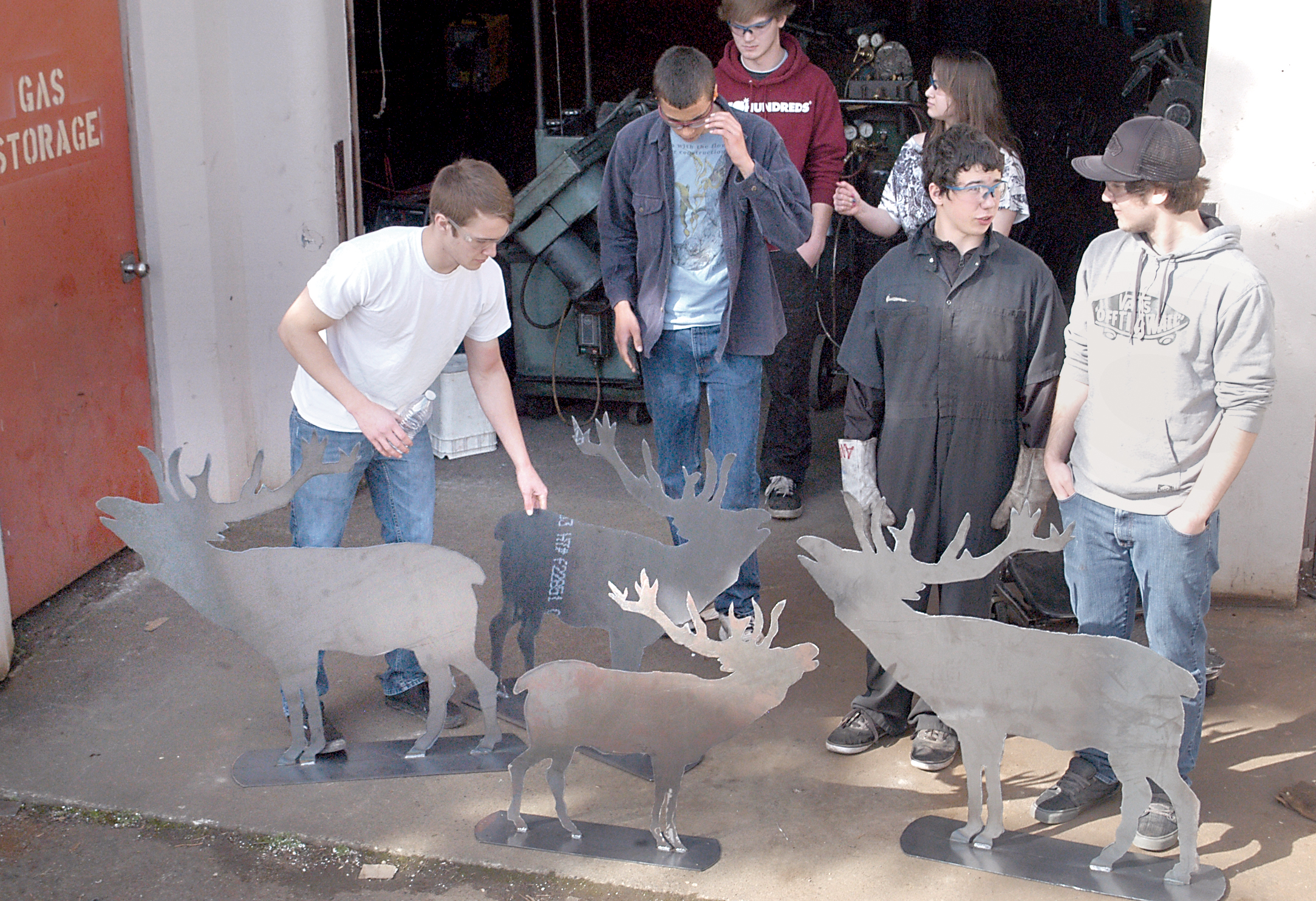 Sequim High School students in Bill Seabolt’s welding class prepare to load elk silhouettes into a truck for transport. From left are Bailey Boyce