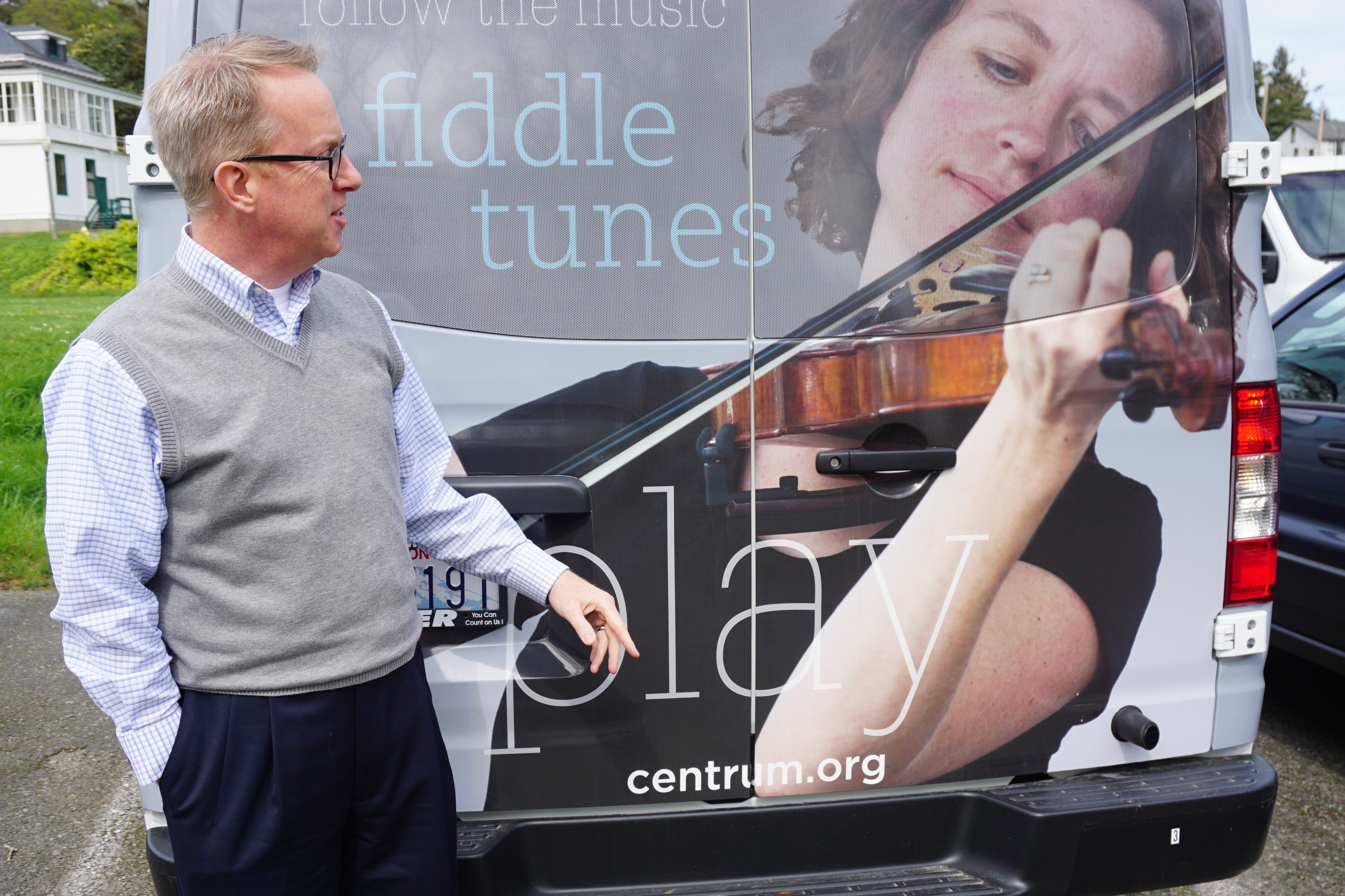 Centrum Executive Director Rob Birman shows off one of the new passenger vans the Fort Worden-based arts organization will use to increase access to programming. This van features fiddler Anya Burgess. — Charlie Bermant/Peninsula Daily News ()