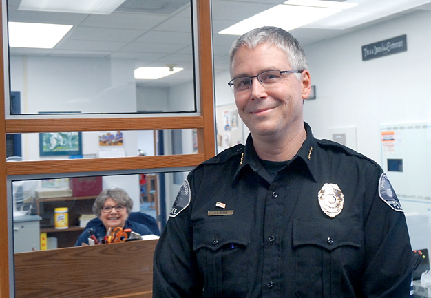 Mike Evans was promoted to Port Townsend police chief on April 1 after serving in the interim position for nearly a year. Also pictured is volunteer Bonnie Toepke. (Charlie Bermant/Peninsula Daily News)