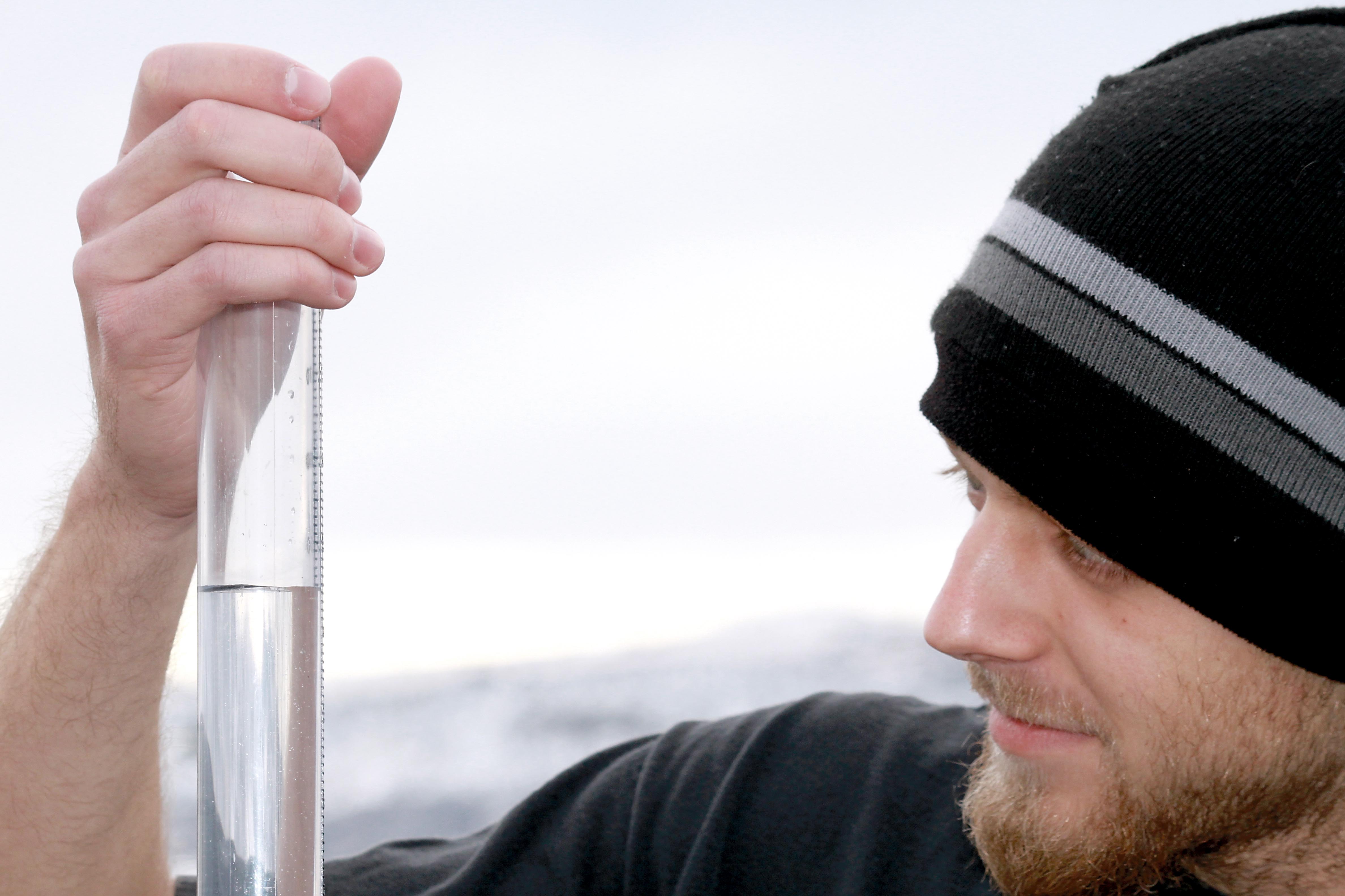 Colorado State University graduate student Morgan Phillips analyzes the contents of a rain gauge on behalf of the Community Collaborative Rain