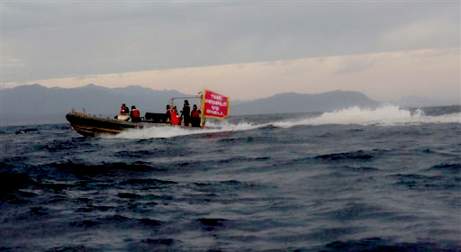 A boat carrying protesters heads out at dawn to meet an oil drilling rig on its arrival Friday in Port Angeles. (Photo by Daniella Beccaria/seattlepi.com via The Associated Press)