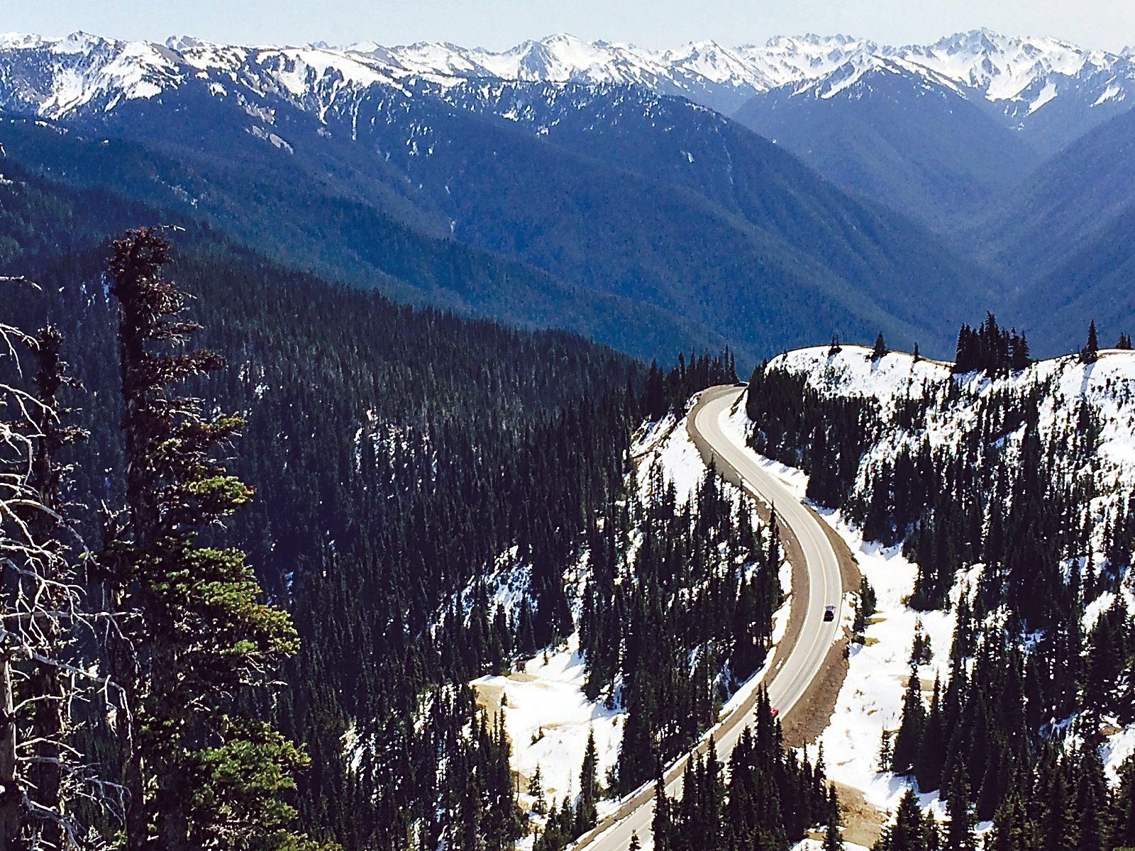 The Olympic Mountains and Hurricane Ridge Road are seen amid melting snow. (Paul Gottlieb/Peninsula Daily News)