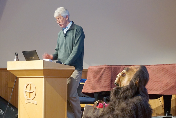 Bob Bindschadler speaks to participants of the Taming Bigfoot competition Friday. Port Townsend High School student Steve Riepe helped hand out awards as Bigfoot. — Charlie Bermant/Peninsula Daily News ()