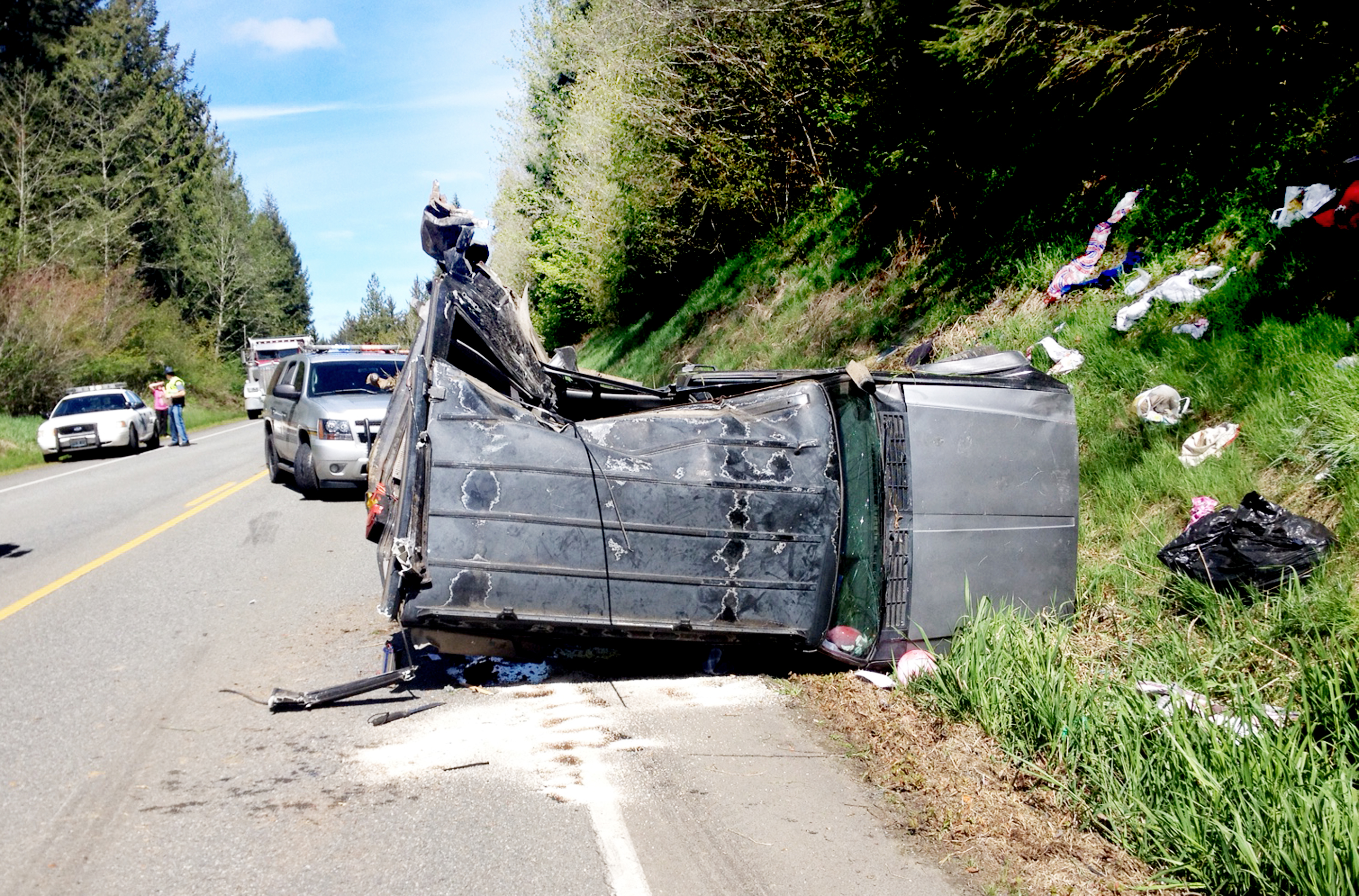 The wreckage of a Jeep SUV in which three people were injured lies Monday afternoon next to U.S. Highway 101 north of Quilcene. (Quilcene Fire Rescue)