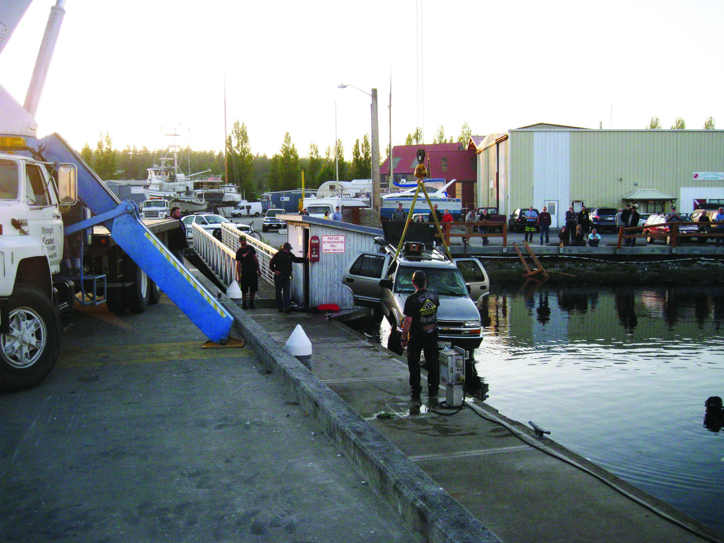 A Chevrolet Trailblazer is hauled out of the water across from Goldstar Marine in Port Townsend on Tuesday after its driver mistook the gas pedal for the brake and crashed through a barrier and into the water. (Jeremy Vergin/Port Townsend Police Department)