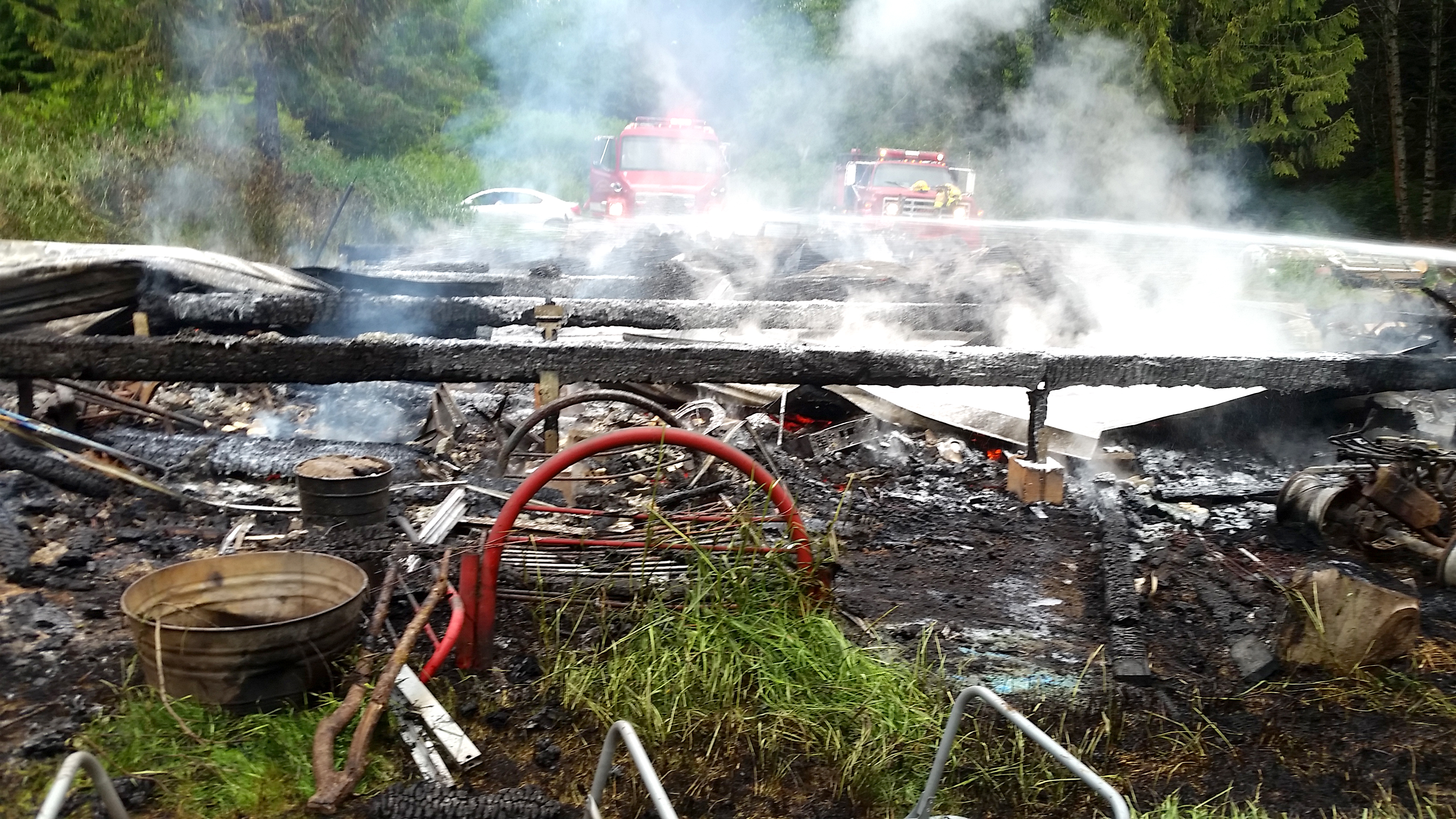 The remains of a Clallam Bay home smolder following a Sunday blaze on Hoko-Ozette Road. (Clallam Fire District No. 5)