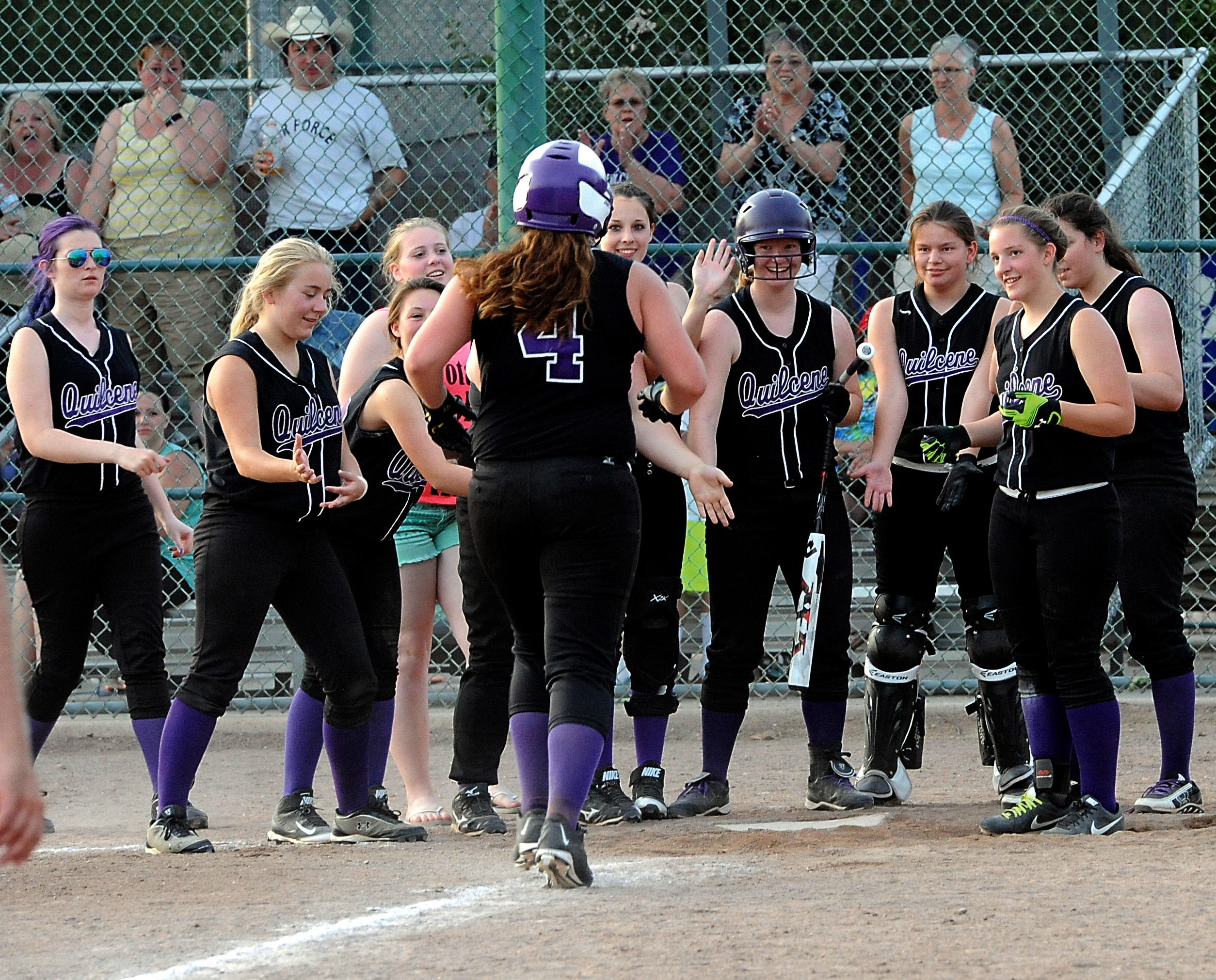 Quilcene's Sammy Rae (4) is greeted at home after hitting a home run in the Rangers' second-round win over Naselle. (Lonnie Archibald/for Peninsula Daily News)