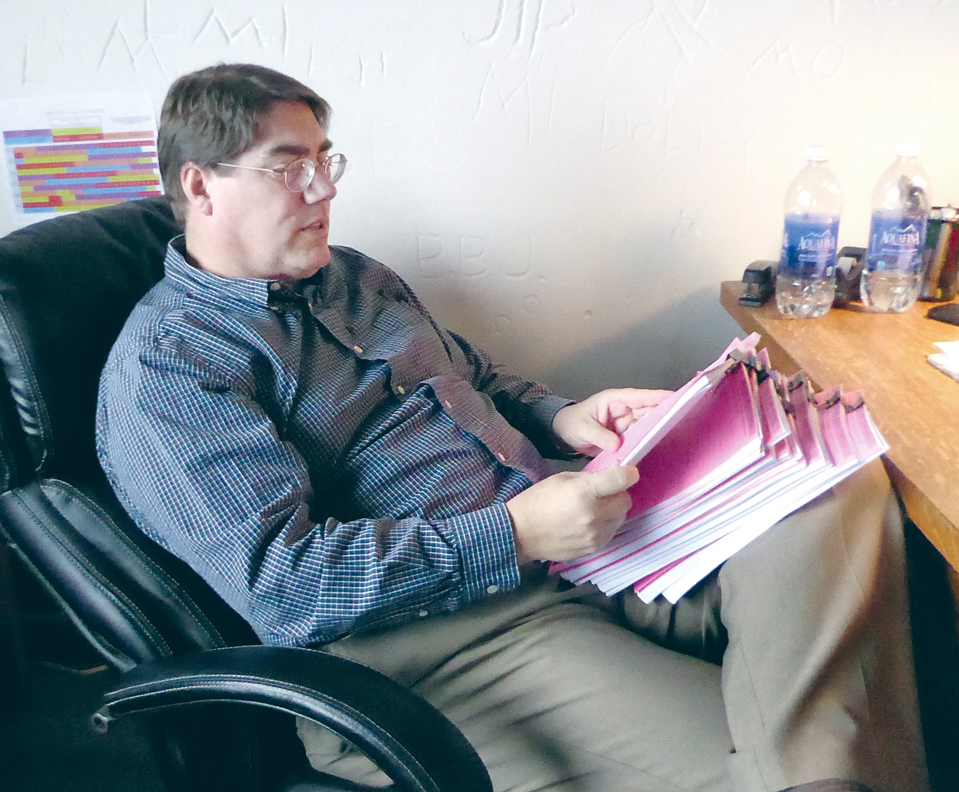 Jefferson County Prosecuting Attorney Michael Haas reviews individual files of each teenager cited after a Sunday post-prom party. (Charlie Bermant/Peninsula Daily News)