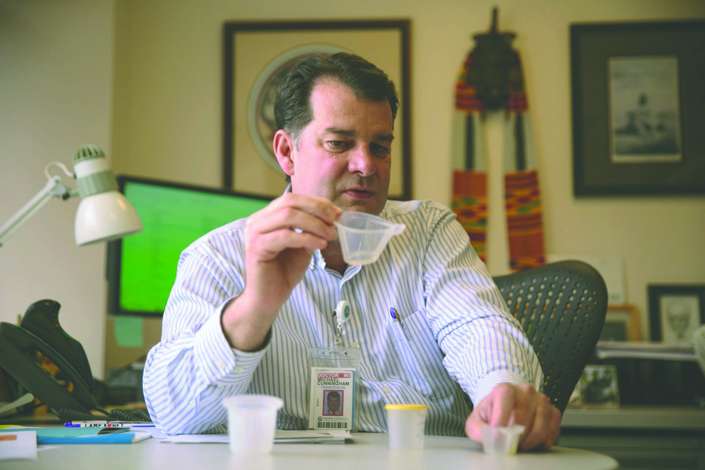 Dr. Michael Cunningham of the Seattle Children’s craniofacial center holds a NIFTY cup in Seattle. — Erika Schultz /The Seattle Times via AP ()