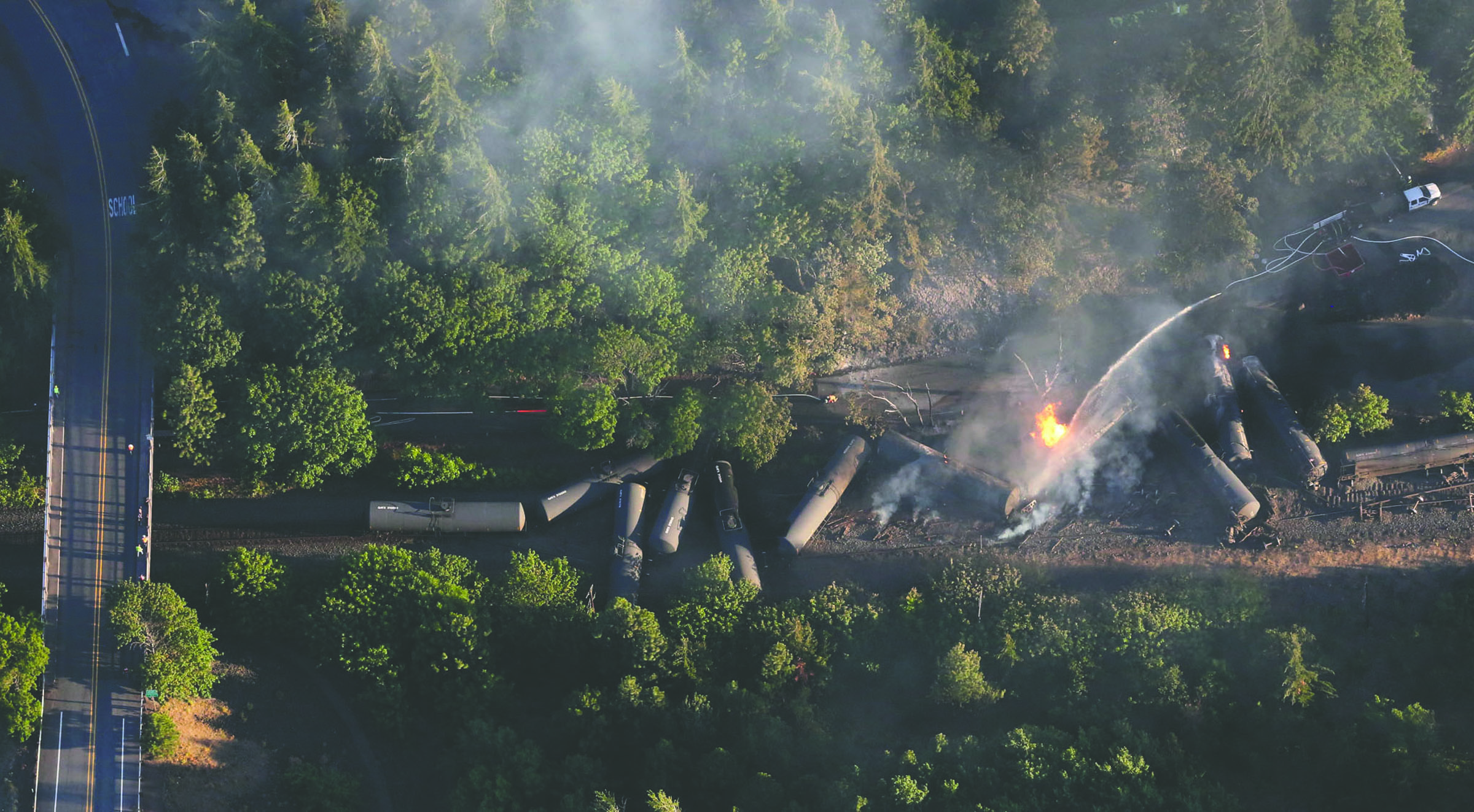 An oil train burns near the Oregon town of Mosier after derailing Friday. — Alan Berner/The Seattle Times via AP ()