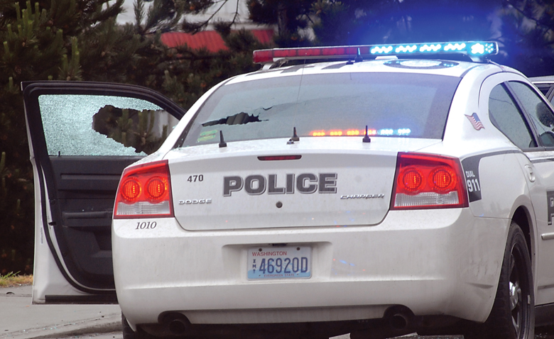 A Port Angeles police cruiser with its windows shot out after a short police chase that ended with the driver of the fleeing vehicle being shot by police after firing on them. (Keith Thorpe/Peninsula Daily News)