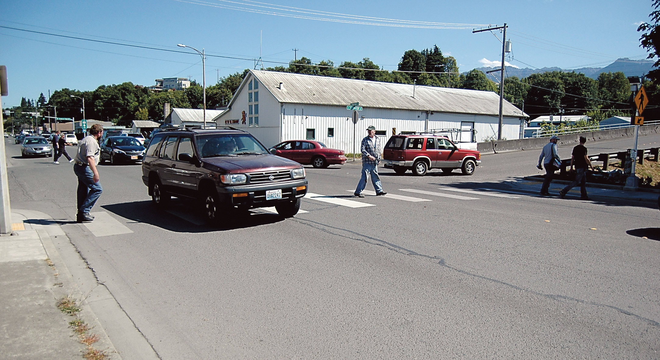 Westport LLC workers cross Marine Drive at the congested Tumwater Street intersection