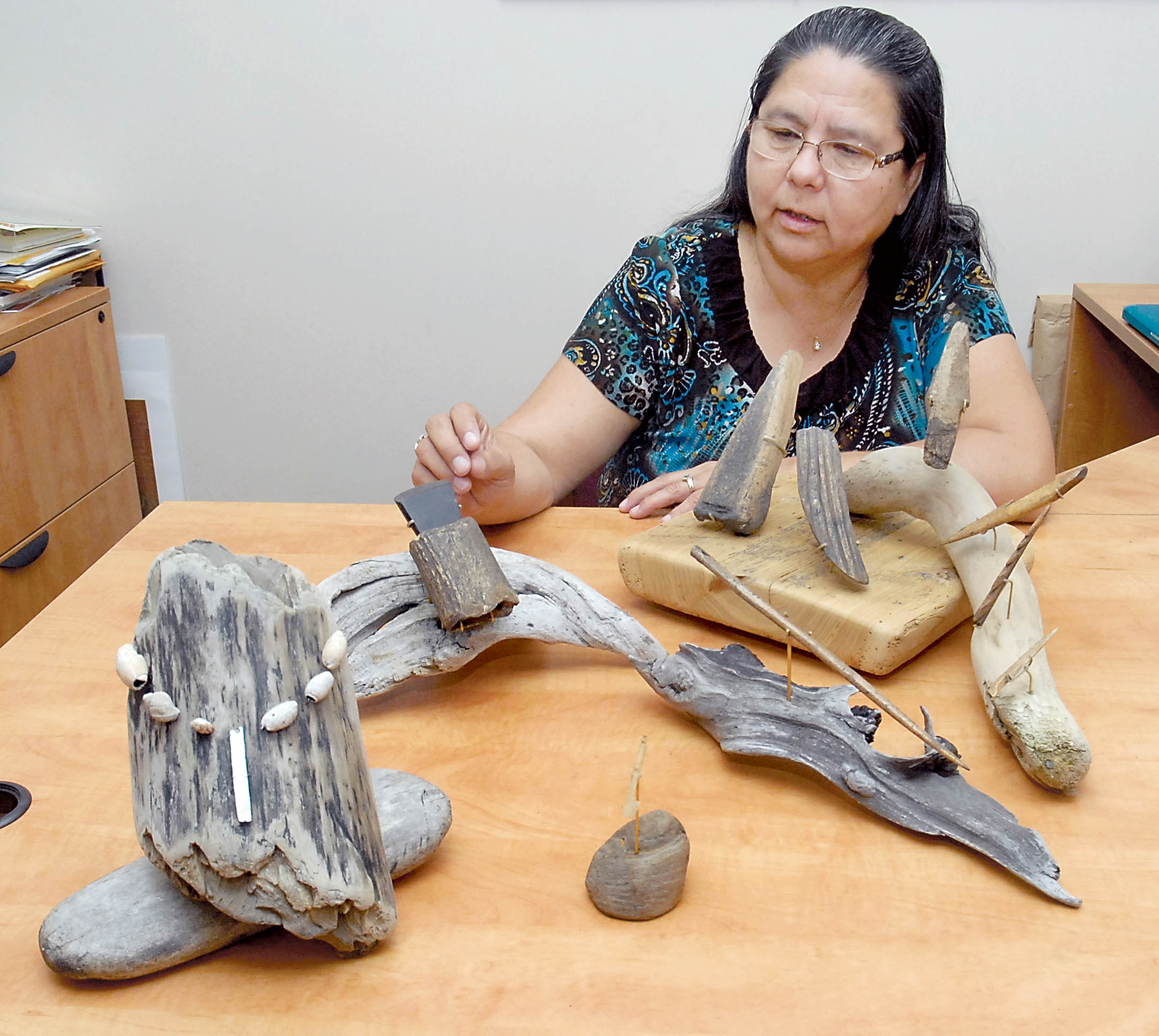 Lower Elwha Klallam Tribal Chairwoman Frances Charles examines a collection of artifacts from the Tse-whit-zen village site that will go on display today (Friday) at the Elwha Klallam Heritage Training Center in Port Angeles. —Photo by Keith Thorpe/Peninsula Daily News