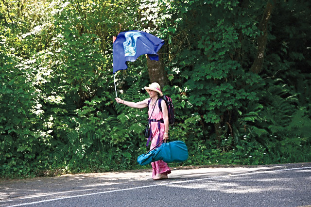 Sallie “Spirit” Harrison walks along U.S. Highway 101 on her way to Lake Quinault.