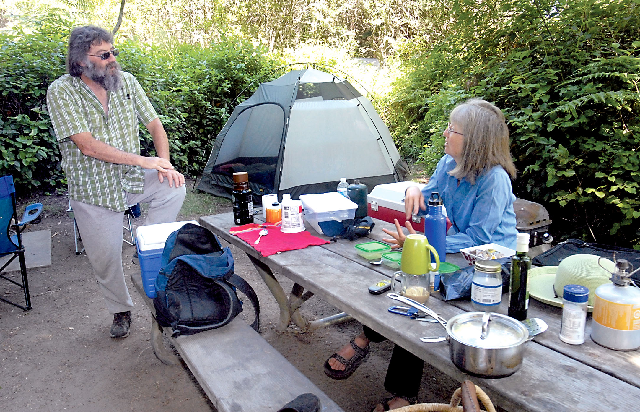 Russ Levine and Ann Marie Fischer hang out at their campsite at the Dungeness Recreation Area north of Sequim. —Photo by Keith Thorpe/Peninsula Daily News