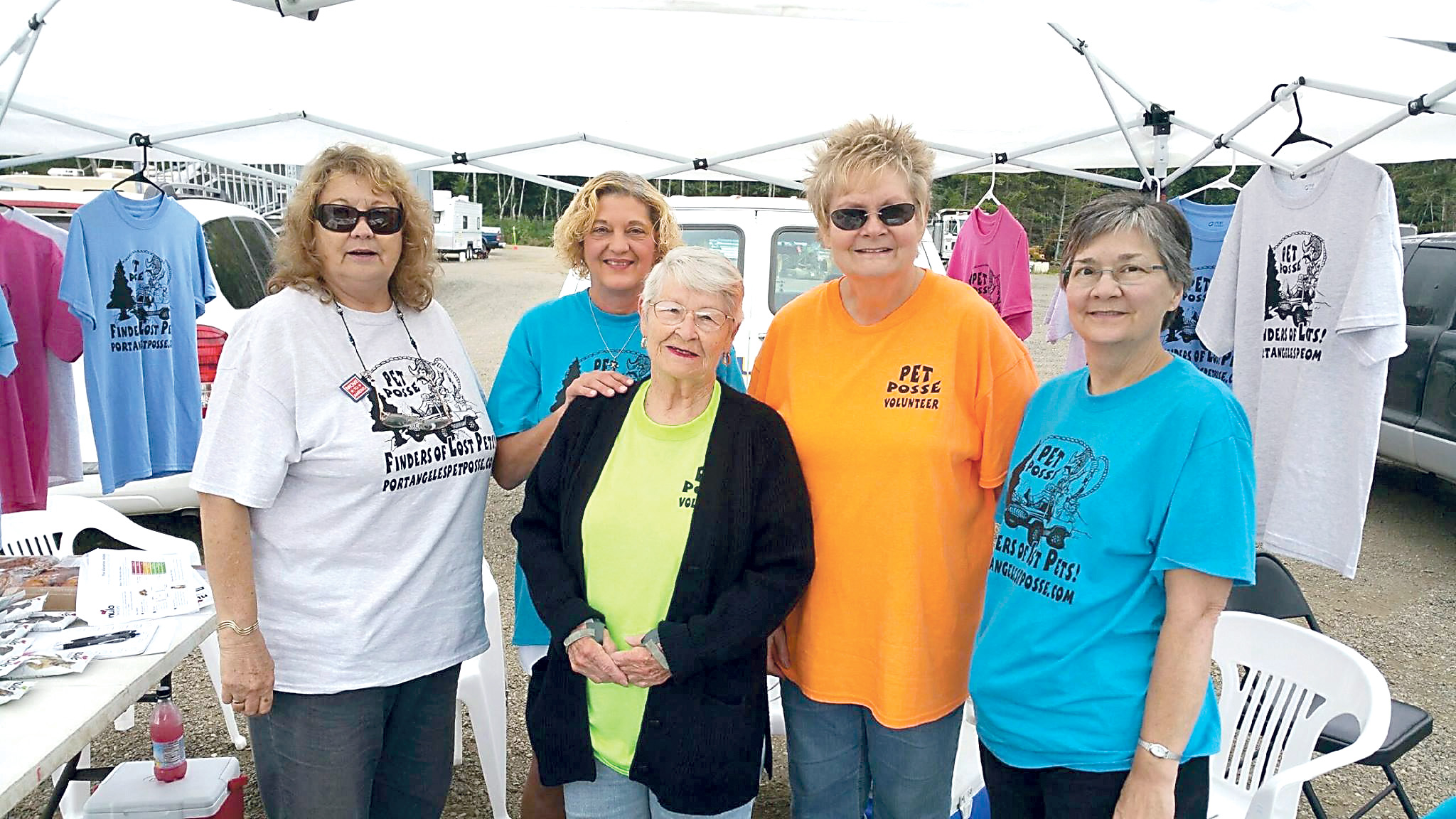 Founders and core volunteers for Port Angeles Pet Posse set up an information tent at the Run A Muck at the Extreme Sports Park on Saturday. The Pet Posse is