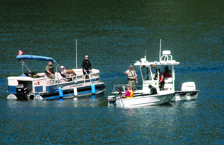 Rescue boats and a Clallam County Sheriff’s Office vessel are joined by a dive boat in the search for a person reportedly drowned Friday in Lake Sutherland west of Port Angeles. — Keith Thorpe/Peninsula Daily News ()