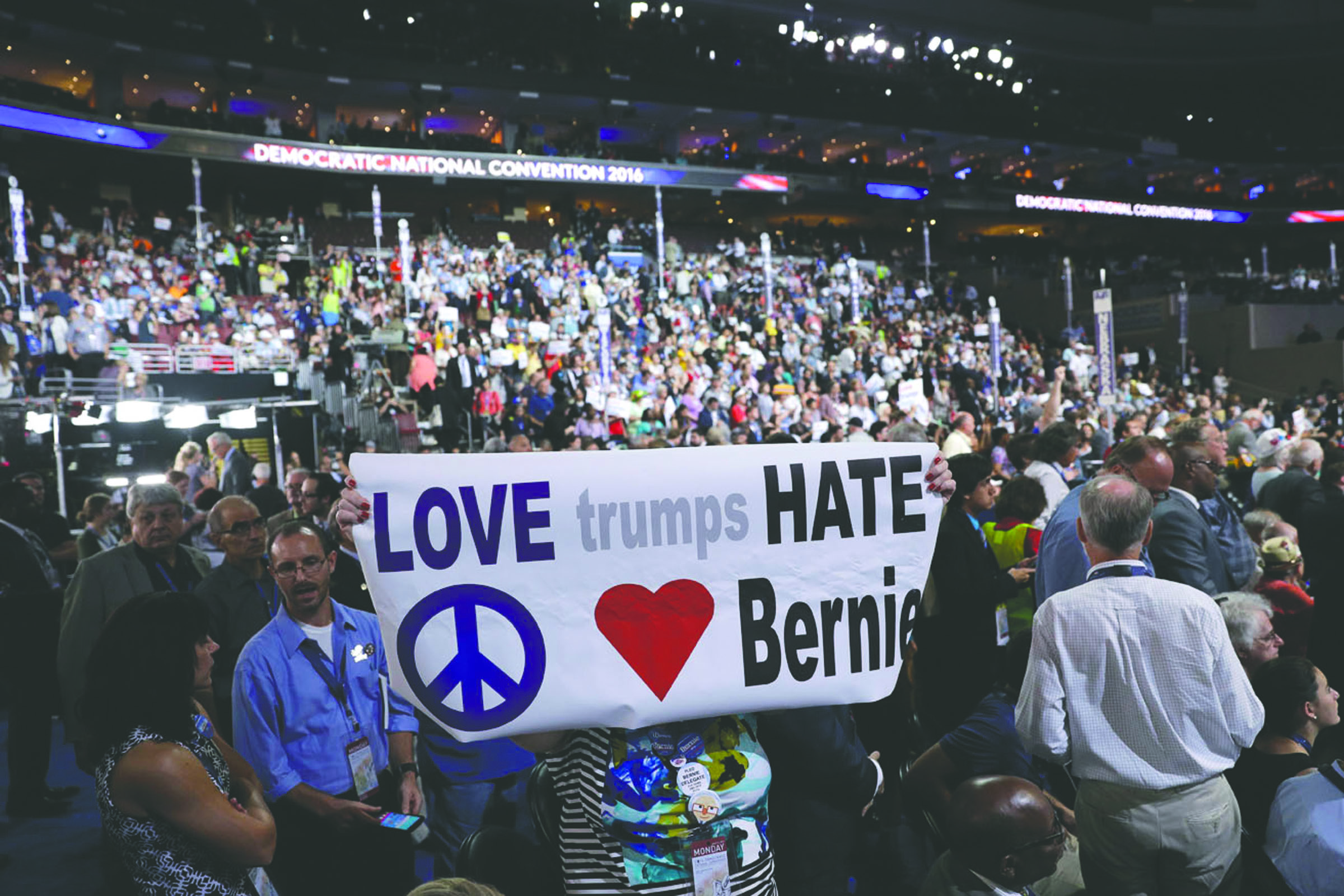 Delegates hold up signs during the first day of the Democratic National Convention in Philadelphia on Monday. — The Associated Press ()