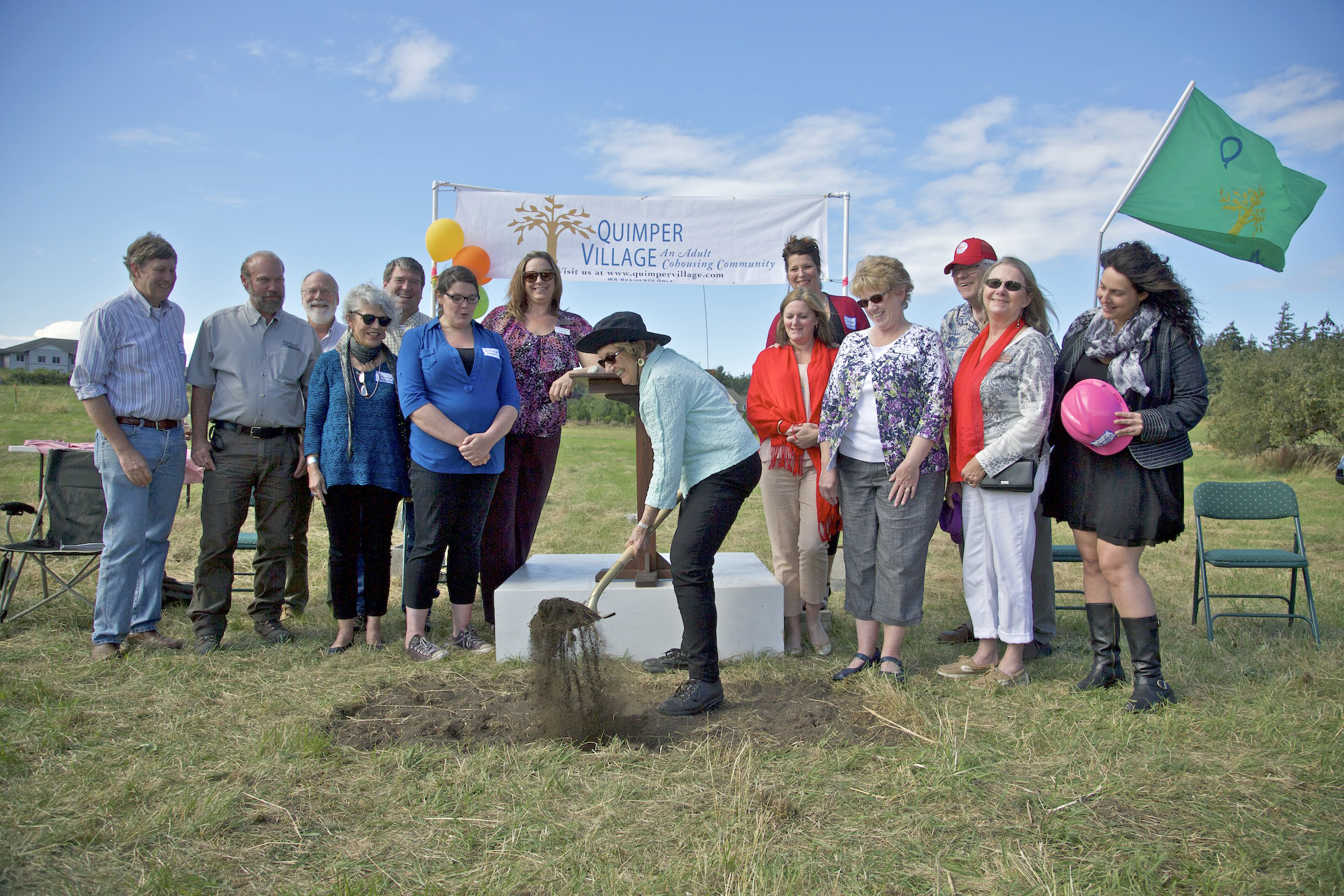 Co-founder Pat Hundhausen turns the first spade of earth at the Quimper Village building site in Port Townsend. ()