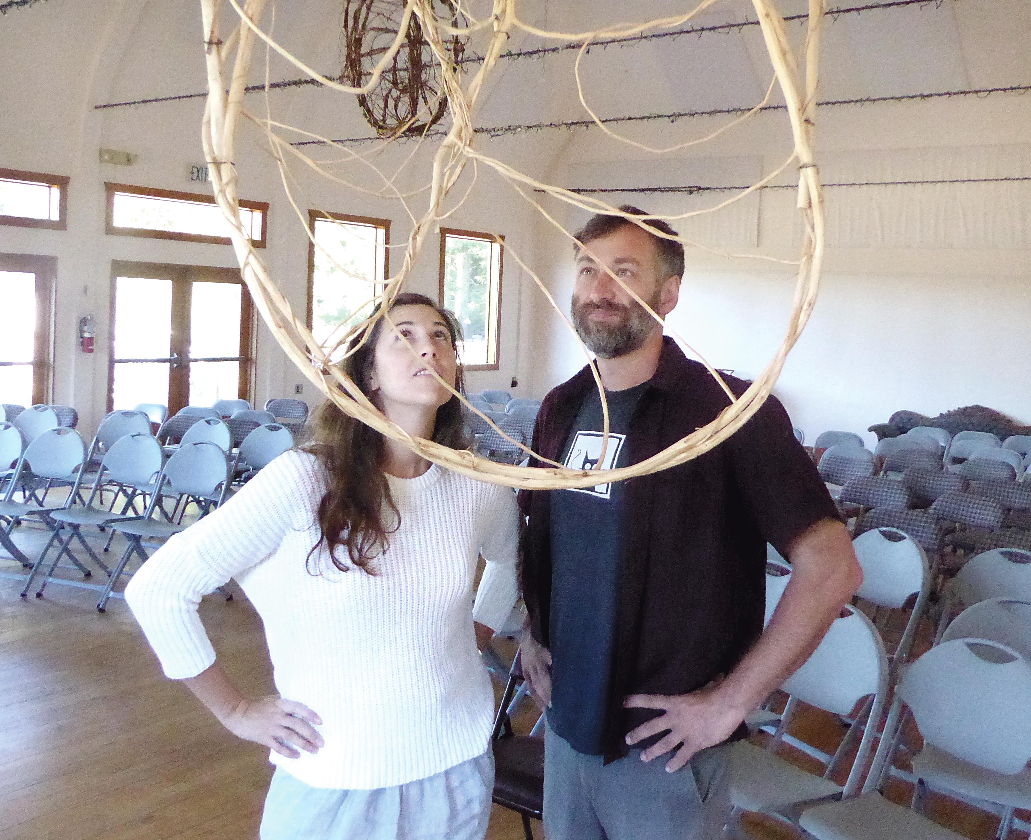 Claire Cunningham and Ben Thomas hang a new sculpture inside the recently reopened Palindrome