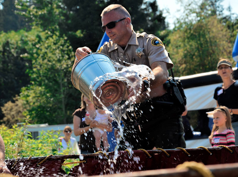 Clallam County Sheriff's Deputy Brian Stoppani participates in an activity as part of 2014's Unity of Effort Picnic in Gardiner.