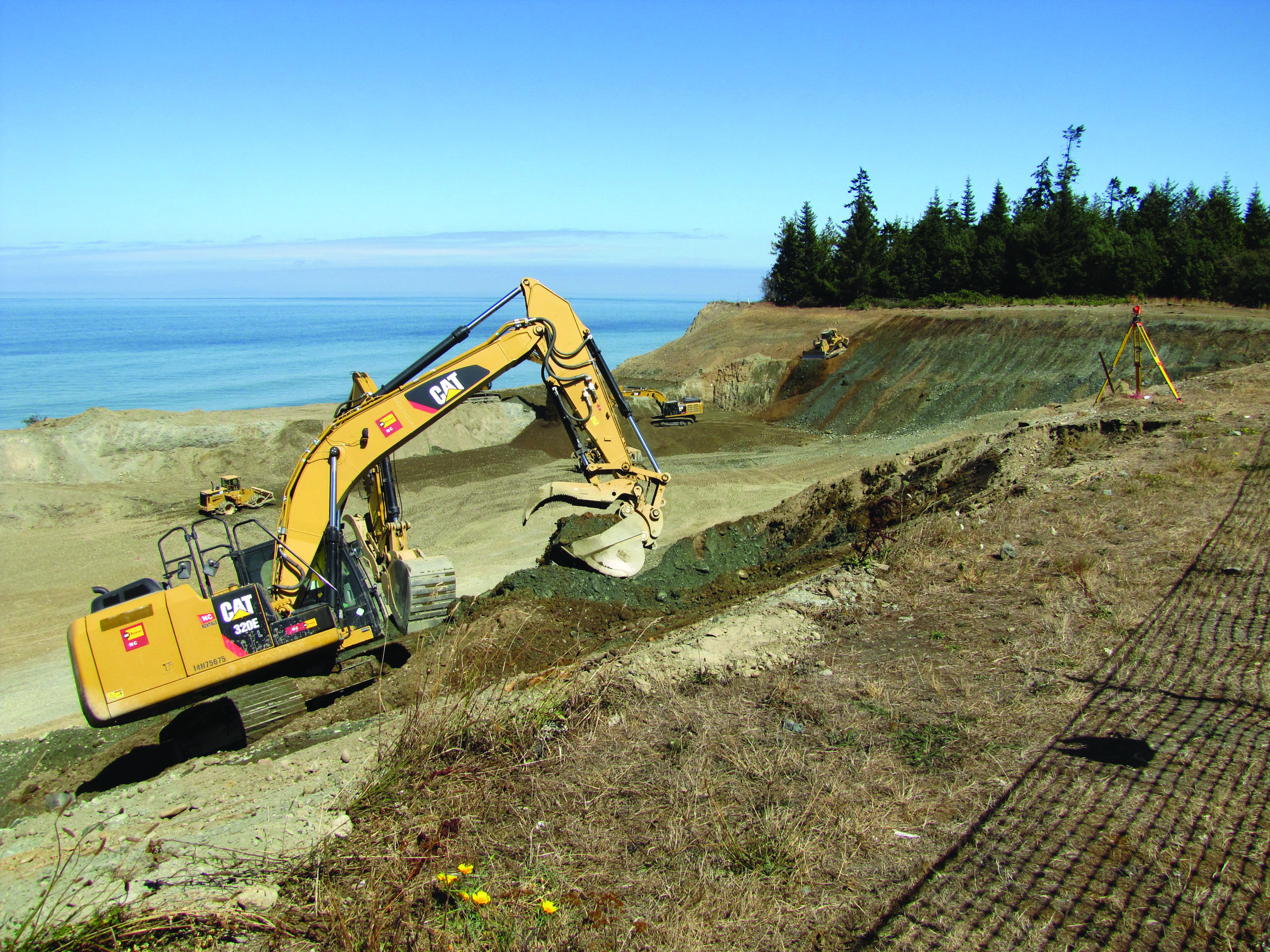 Crews on Thursday grade the closed Port Angeles landfill area where garbage was moved away from the bluffs overlooking the Strait of Juan de Fuca. Arwyn Rice/Peninsula Daily News