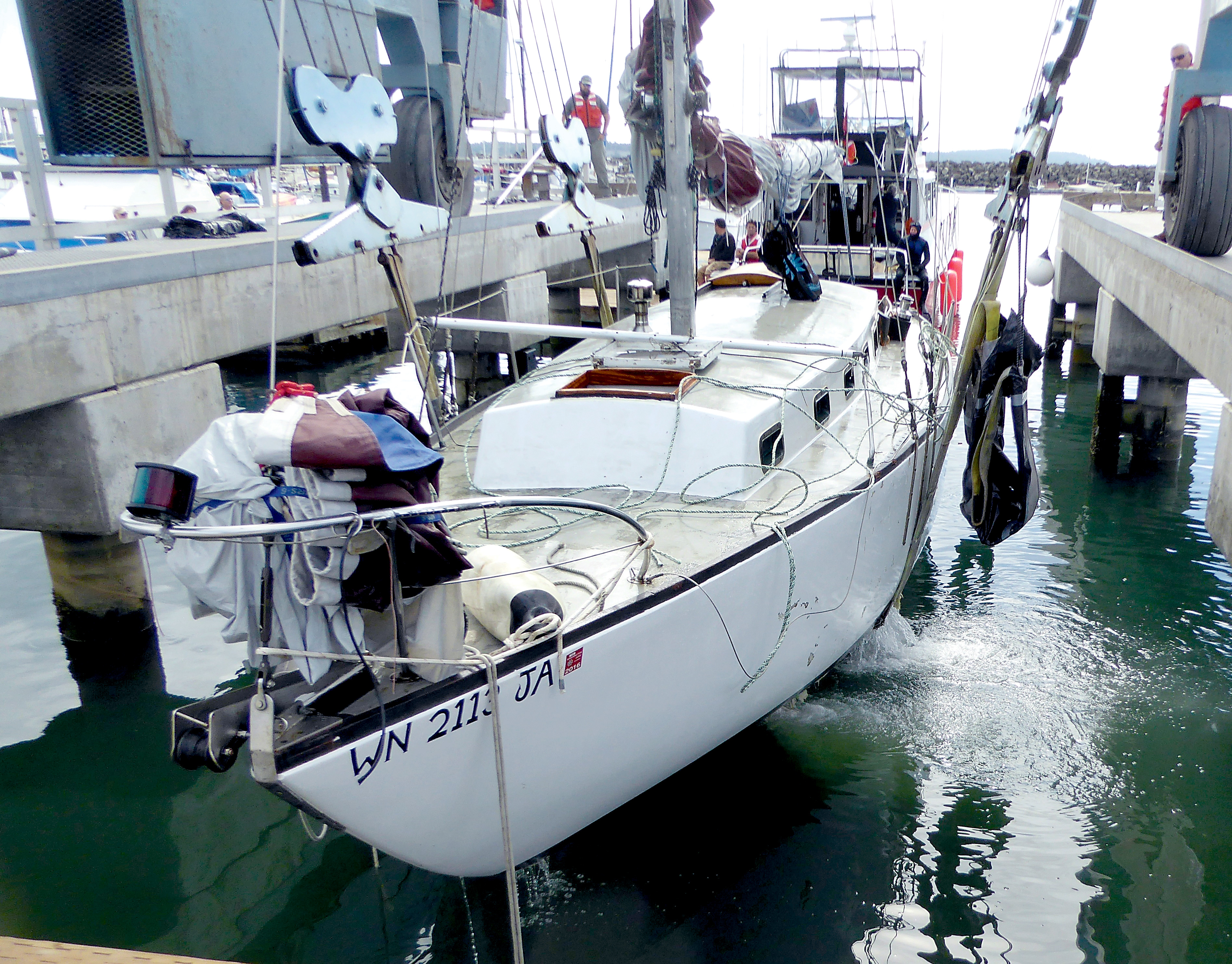 Divers pull the Skybird out of the water Thursday. The vessel was damaged in Saturday's storm. Charlie Bermant/Peninsula Daily News