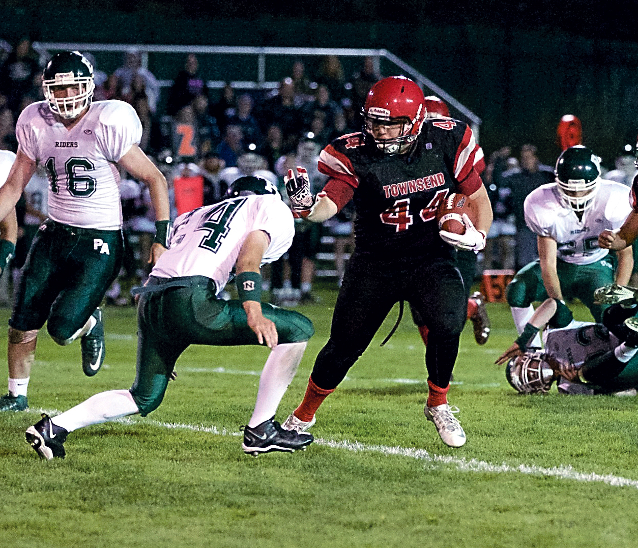 Port Townsend running back Wesley Wheeler (44) pushes off and gets around Port Angeles' Caleb Joslin. Steve Mullensky/forPeninsula Daily News