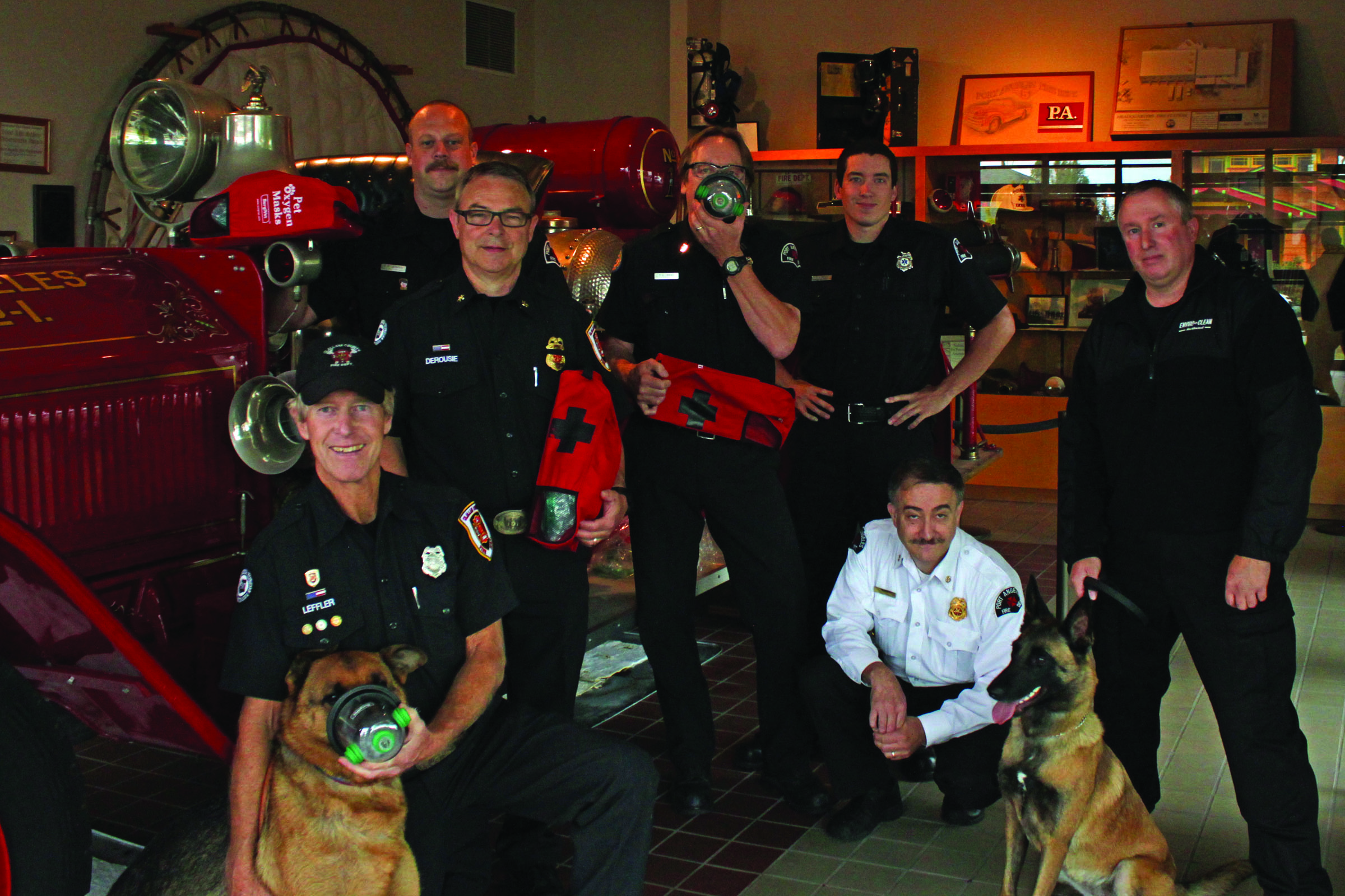 Clallam County emergency responders pose with dogs and new pet oxygen masks purchased by local businesses. From left are Clallam Fire District No. 2 firefighter Rick Leffler with Kodiak and Assistant Chief Mike DeRousie; Port Angeles Fire Department firefighter Erik Sundin