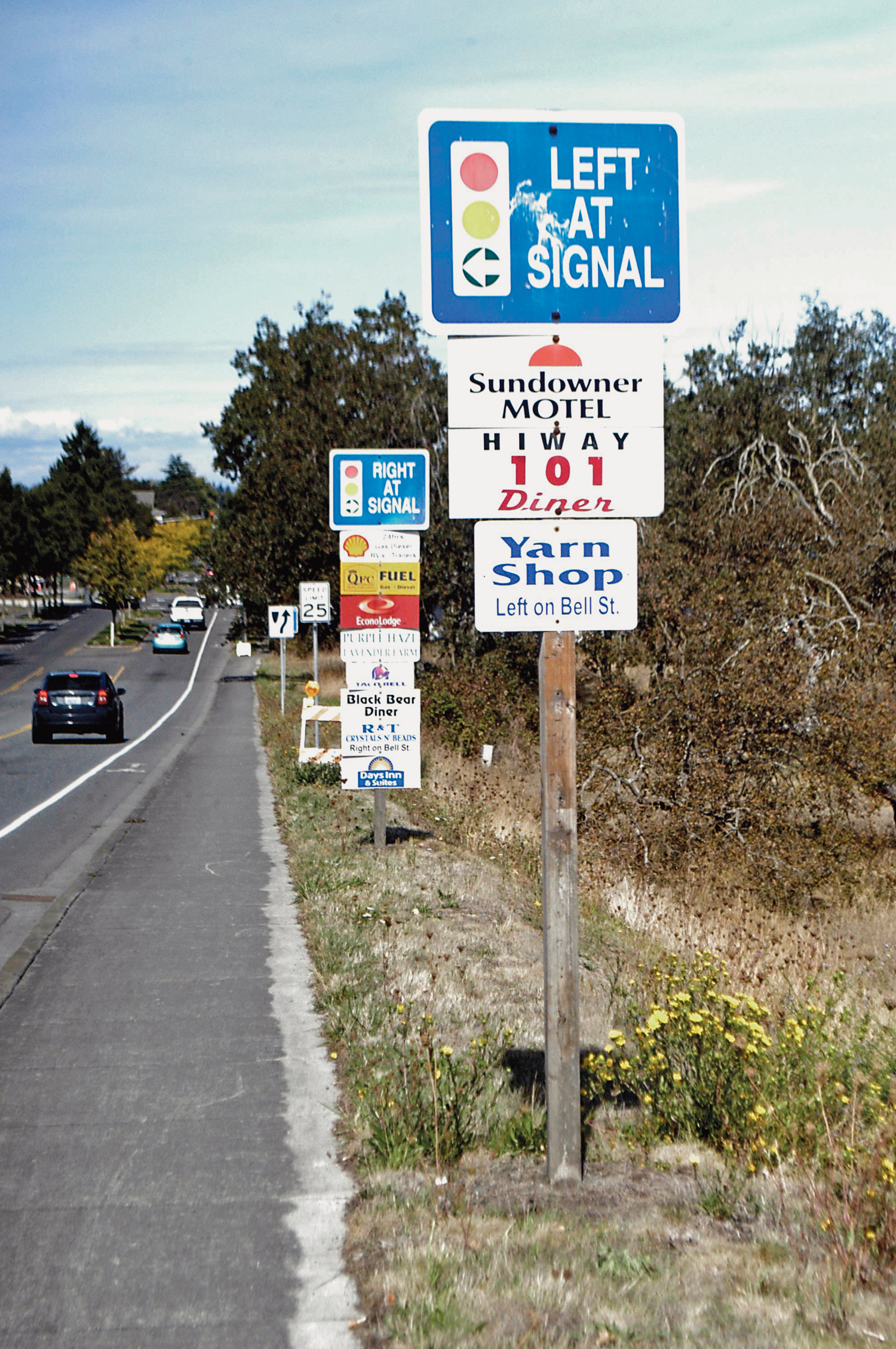 A new ordinance passed by the city of Sequim requires the business signs seen here Wednesday afternoon on South Sequim Avenue to be removed and replaced with a sign approved by the Department of Transportation. — Chris McDaniel/Peninsula Daily News