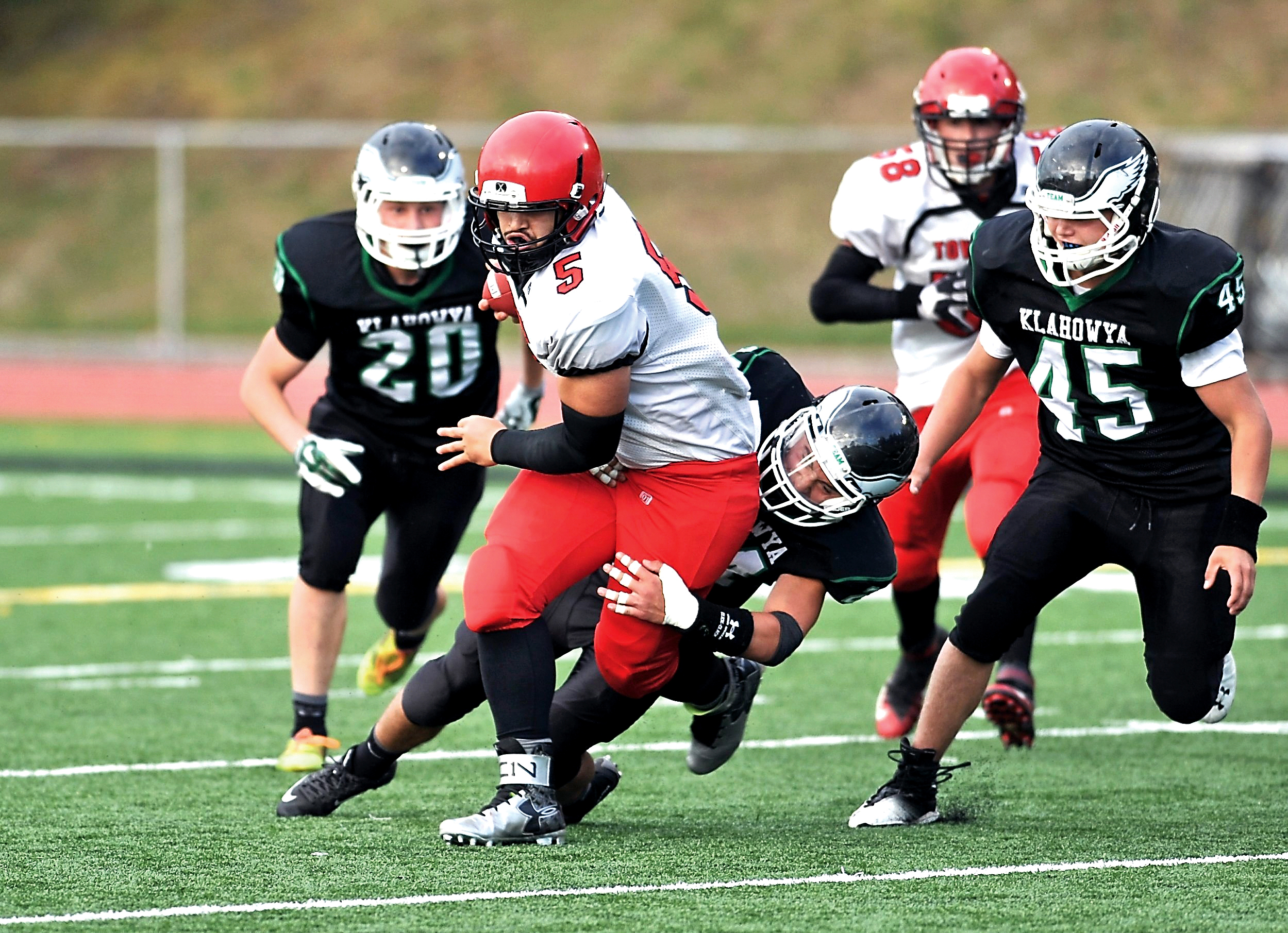 Port Townsend quarterback David Sua (5) runs through a tackle by Klahowya's Lucas Weaver as Jacob Sargent (20) and Tyler Vandergriff (45) close in. Jeff Halstead/for Peninsula Daily News