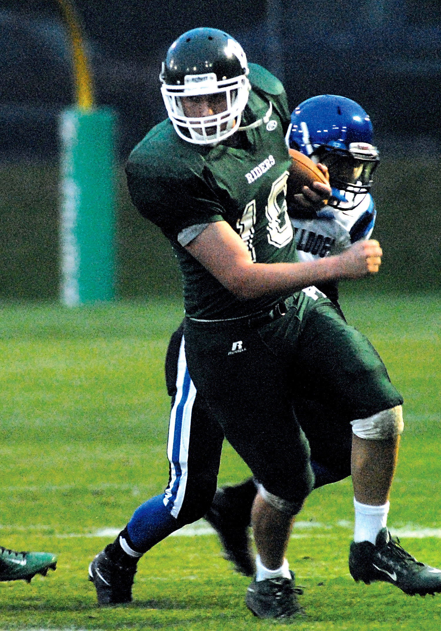 Port Angeles' Kellen Landry tries to escape the tackle of North Mason's Trey Fisher. Keith Thorpe/Peninsula Daily News