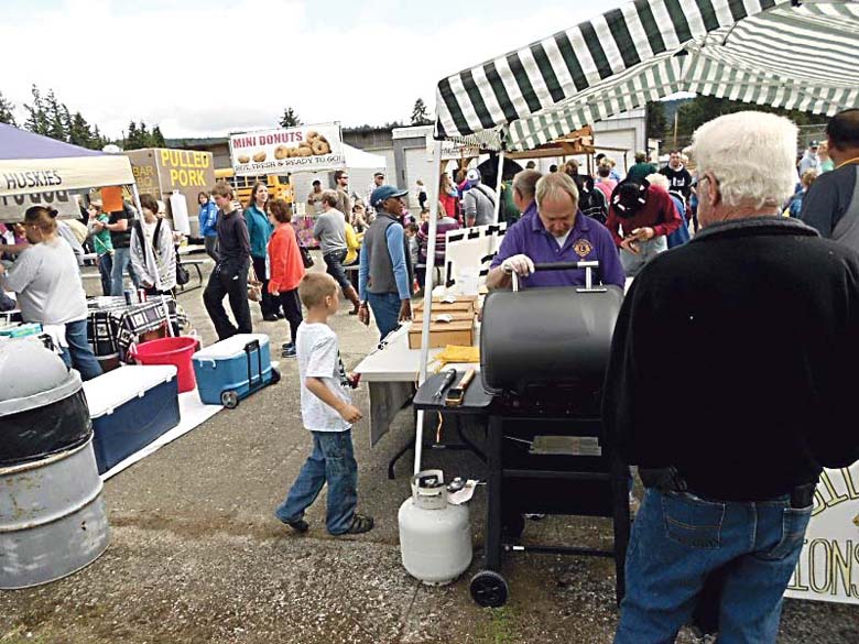 Attendees at the 2014 Quilcene Fair and Parade enjoy the food and crafts booth.