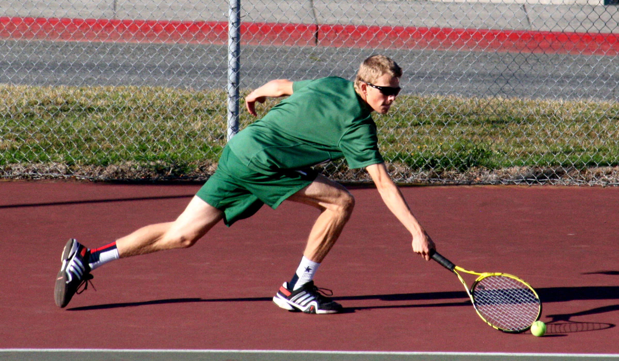 Port Angeles' Janson Pederson reaches for a return against Sequim's Matthew Richards. Pederson won the