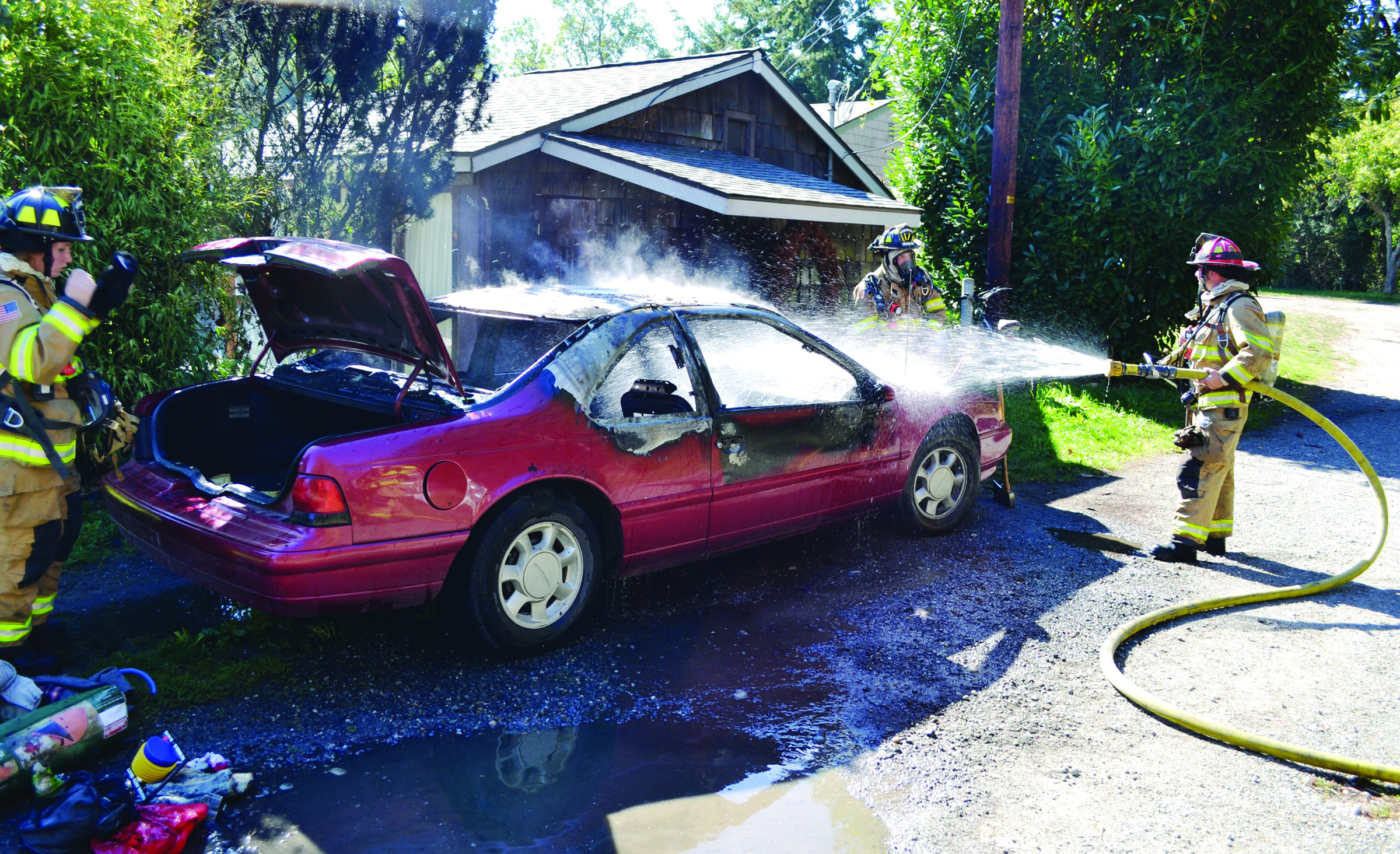 Firefighters with East Jefferson Fire-Rescue respond to a car fire on Third Street in Port Townsend on Tuesday afternoon. Bill Beezley/East Jefferson Fire-Rescue