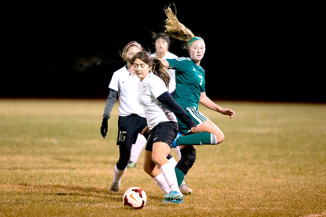 Port Angeles’ Kyrsten McGuffey (7) fends off a trio of East Valley (Yakima) in Yakima on Tuesday night in a state 2A girls soccer tournament match. The Roughriders won 2-0 to move on to the state quarterfinals. (Jake Parrish/Yakima Herald-Republic)