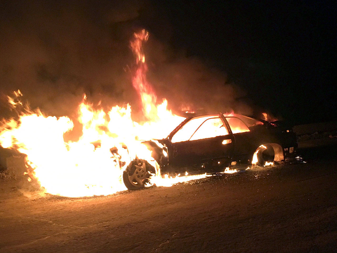 Clallam County Fire District No. 2 firefighters battle a car blaze on U.S. Highway 101 around Lake Crescent. (Clallam County Fire District No. 2)