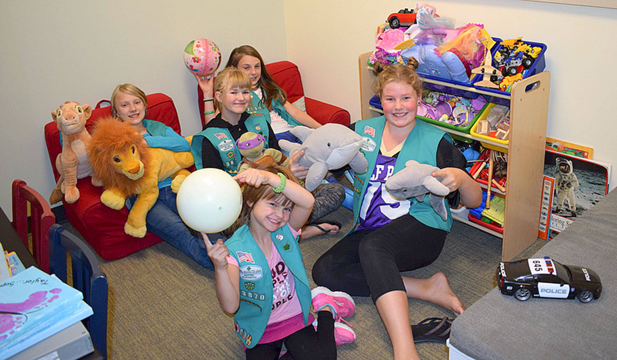 Heidi Krzyworz                                Girl Scouts with Sequim Troop 43870, from left, Johanna Beckerley-Kohl, Sophie Morton, Taylor Heyting, Caydence Barnett and Paige Krzyworz take a moment for a photo as they remodel the child-friendly space in the Sequim Police Department called Cozy Cove.