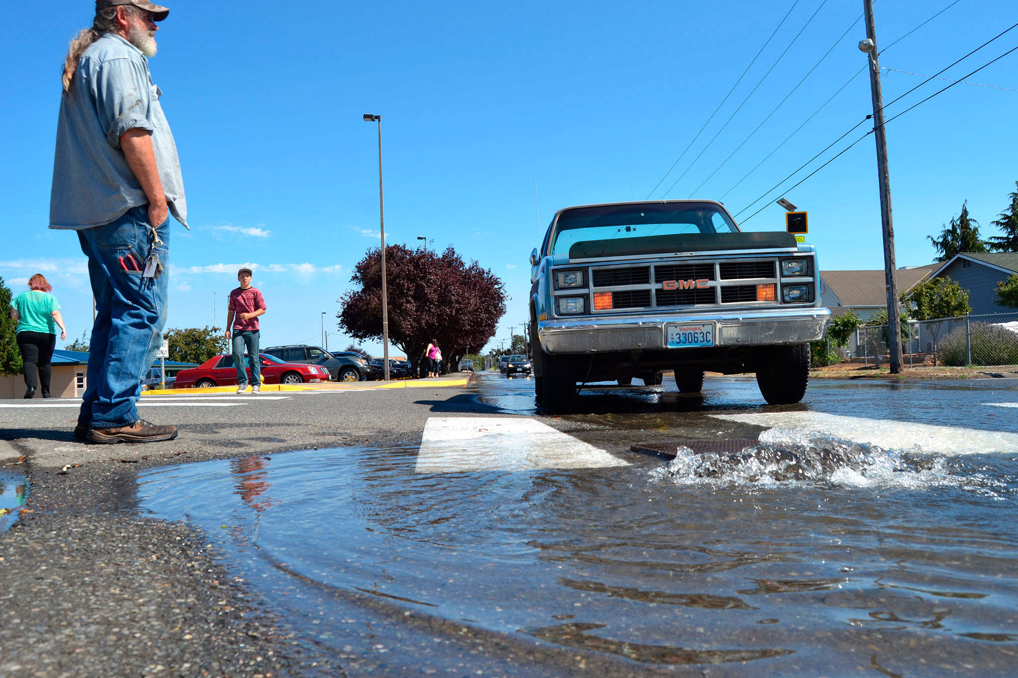 Construction on Fir Street by Sequim schools could start as soon as July 2018, city staff said, to repair water, sewer and irrigation lines, which should solve flooding issues such as this scene from late August. (Matthew Nash/Olympic Peninsula News Group)