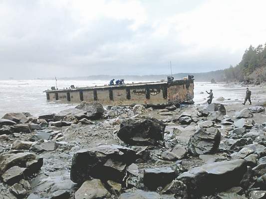 Workers on the Japanese dock that washed up south of LaPush. National Park Service